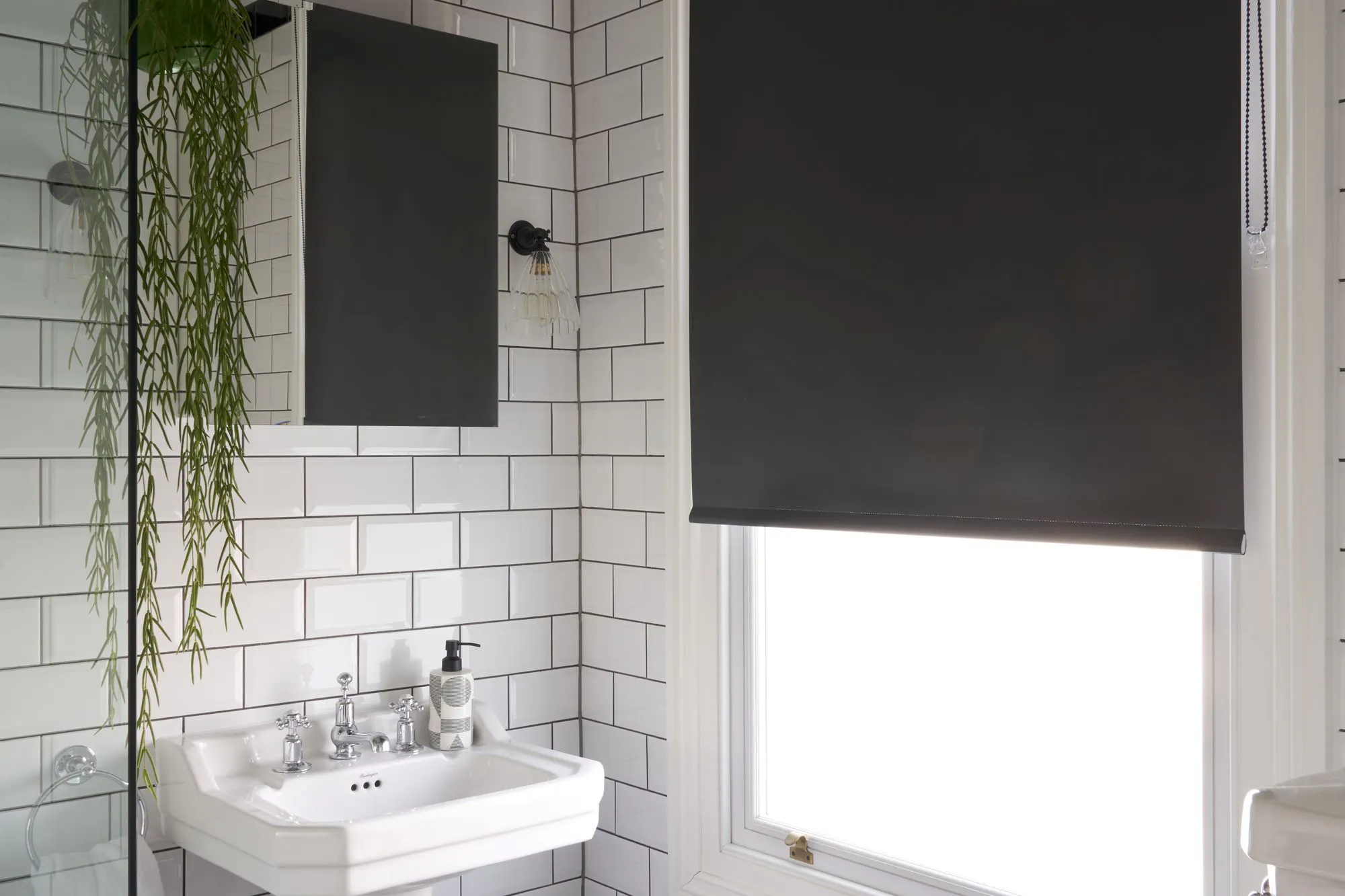 black roller blind in white traditional style monochrome bathroom