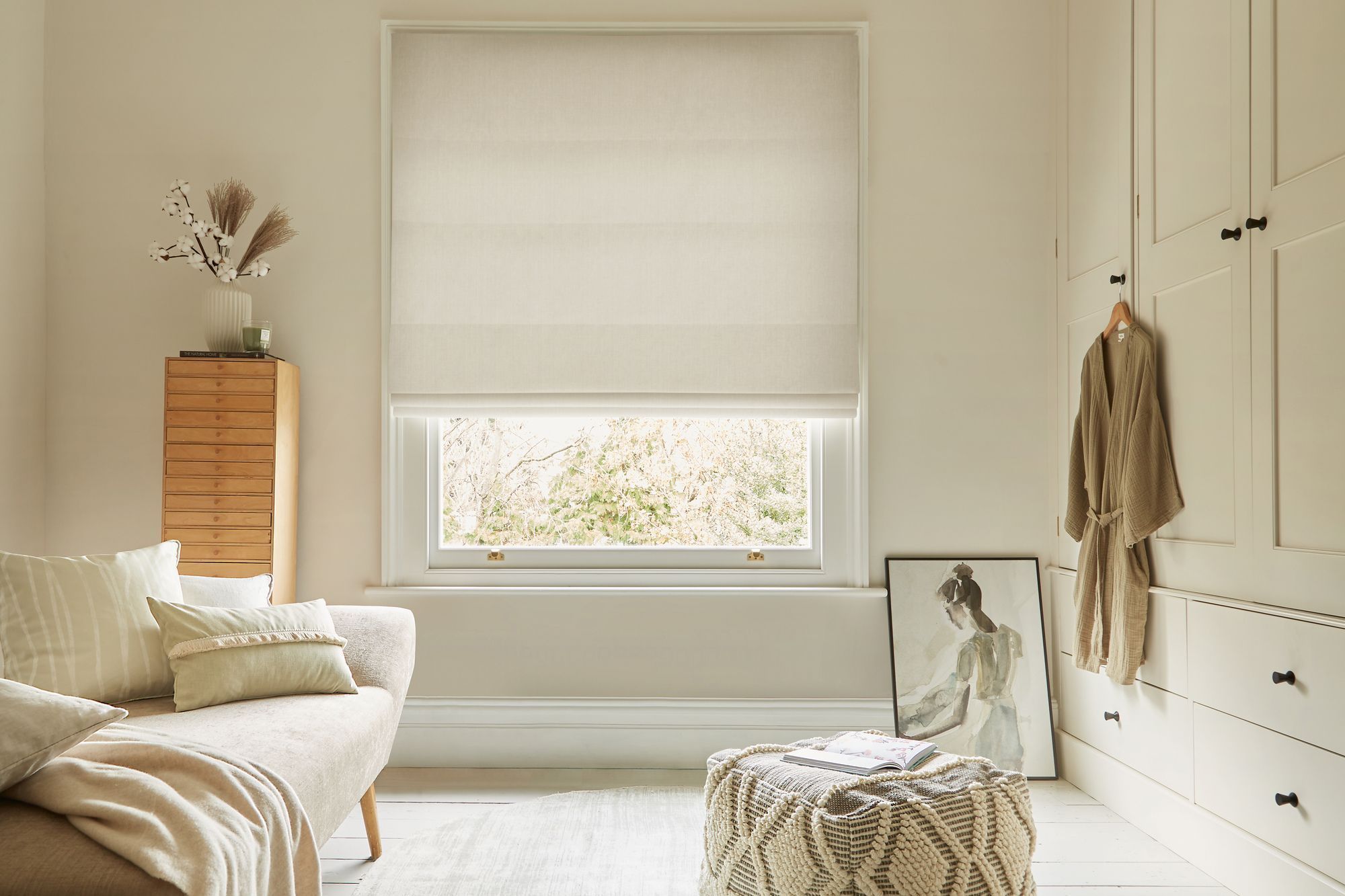 textured white roman blind in neutral dressing room.