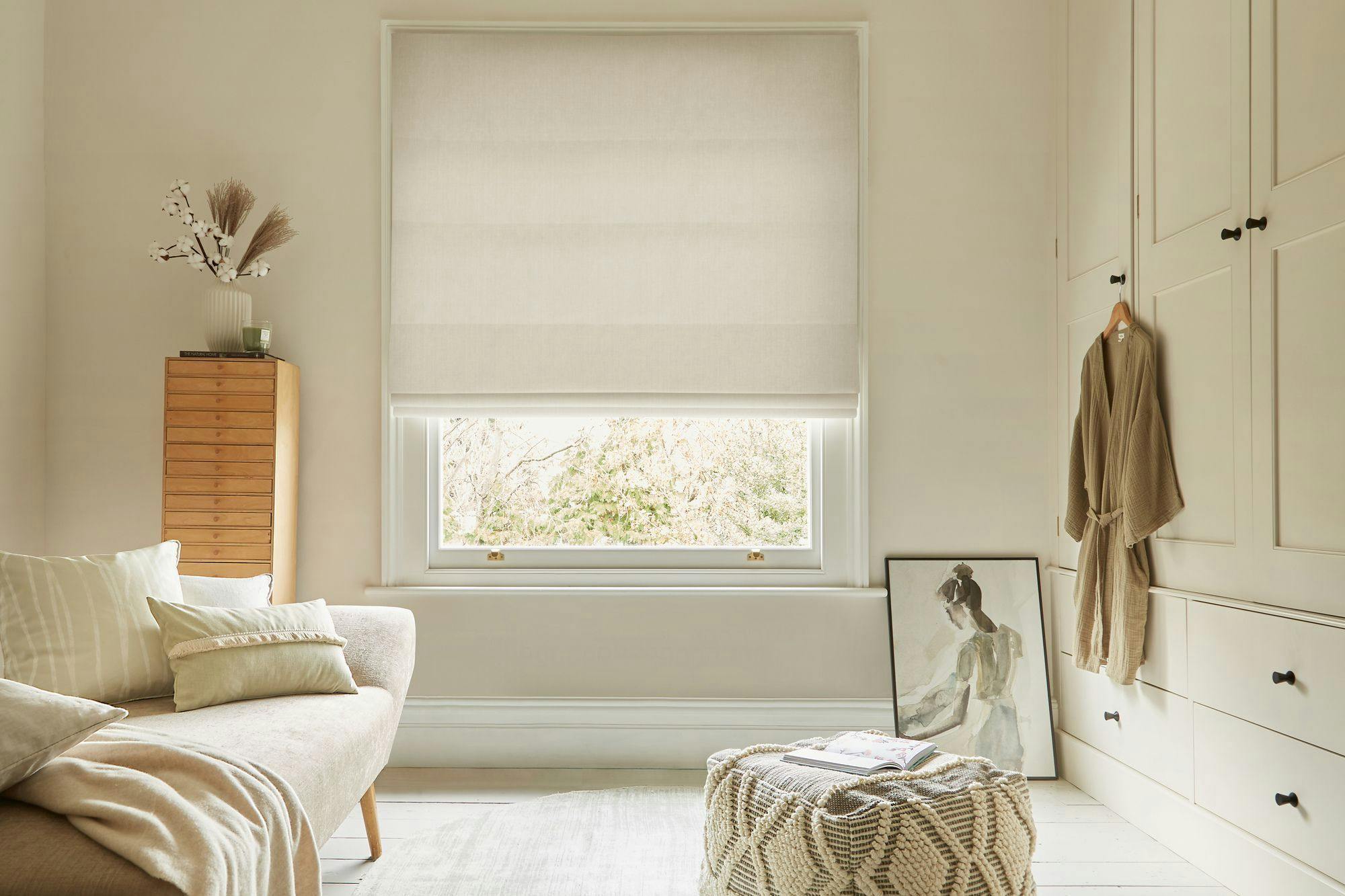 textured white roman blind in neutral dressing room