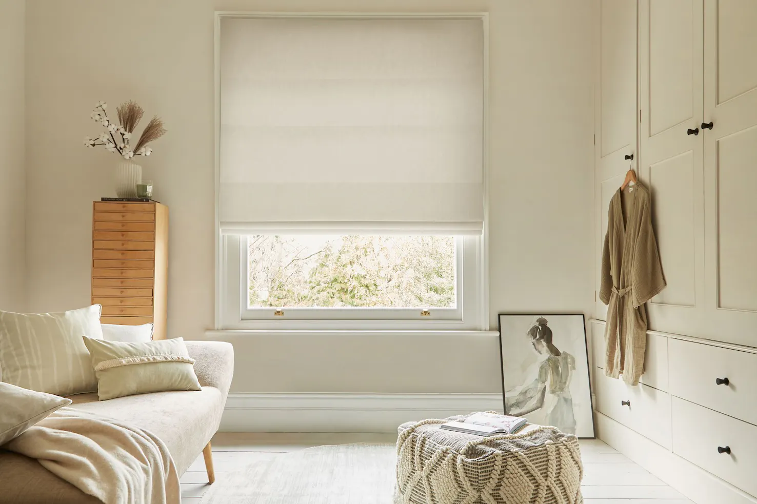 textured white roman blind in neutral dressing room.