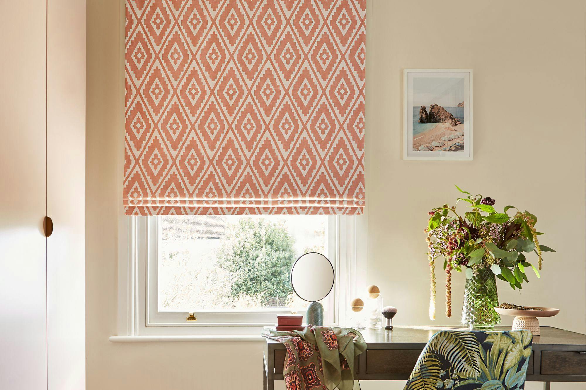 Mali coral orange blinds covering windows in a cream living room