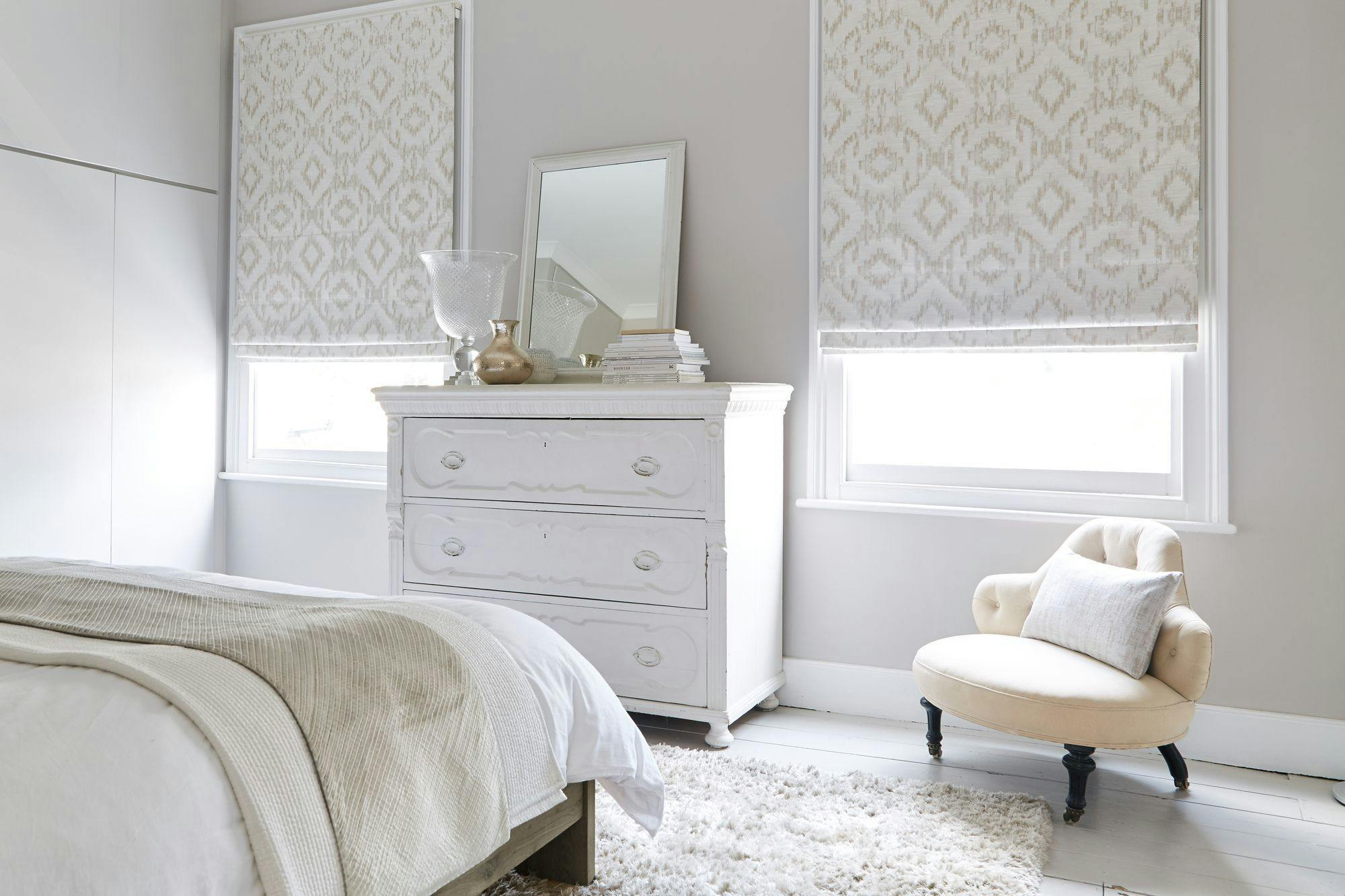 Cream Blackout blinds covering bright bedroom windows