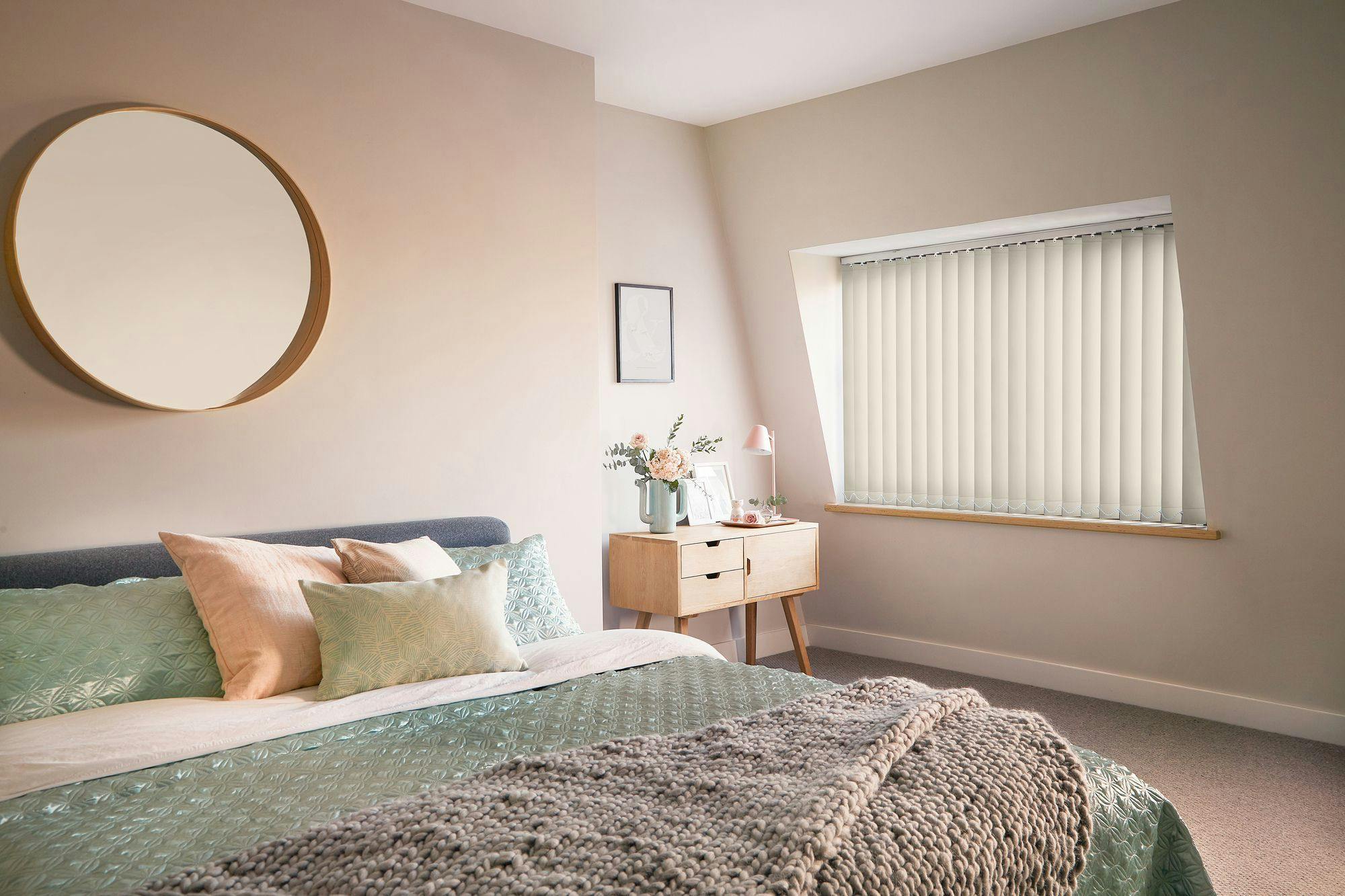 Cream vertical blinds shading a bedroom