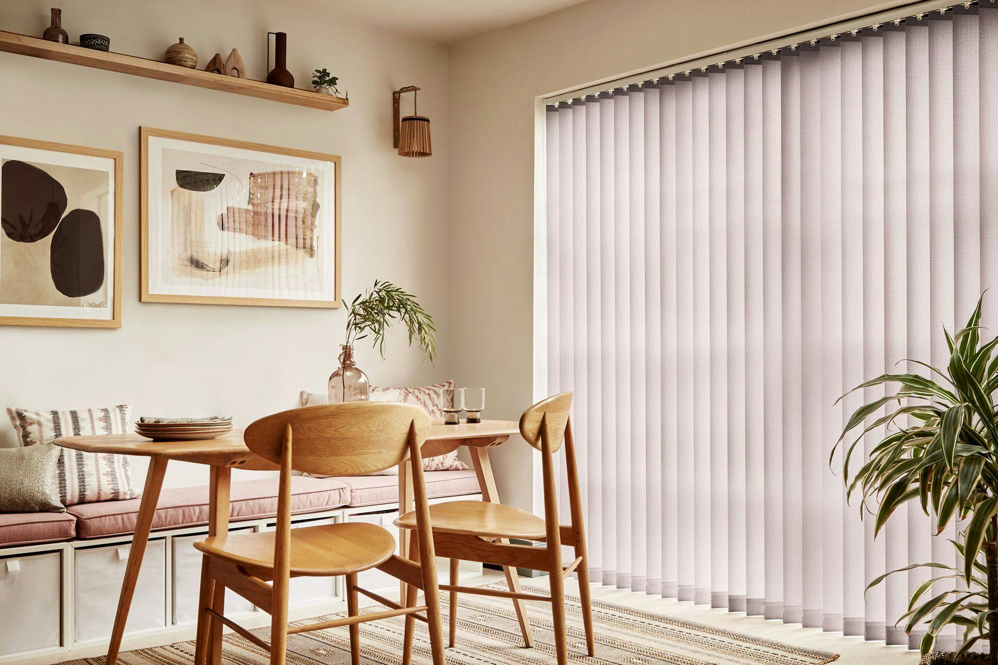 Brown vertical blinds shading tall dining room windows