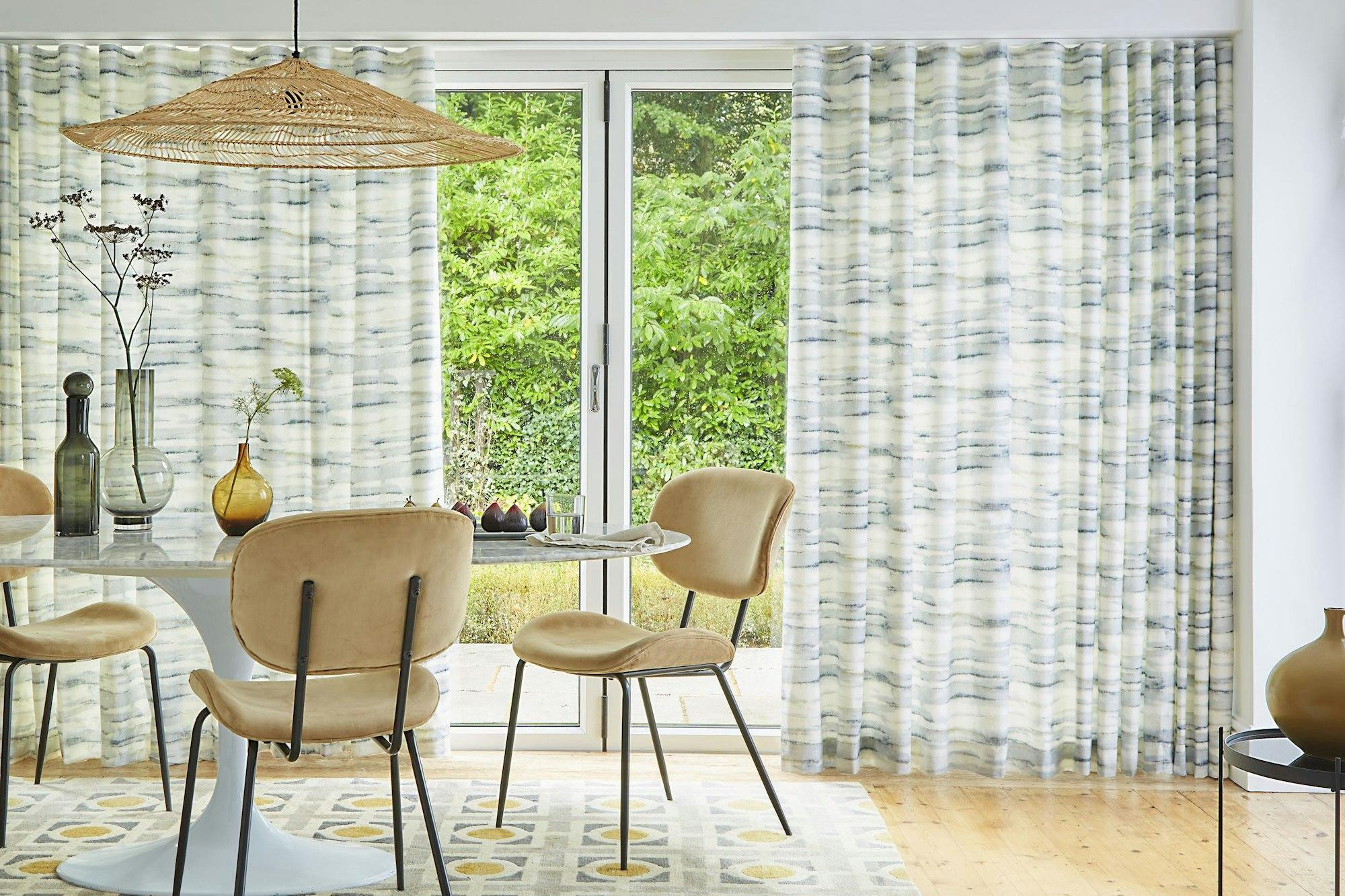 Mist slate patterned wave curtains on patio doors in dining room