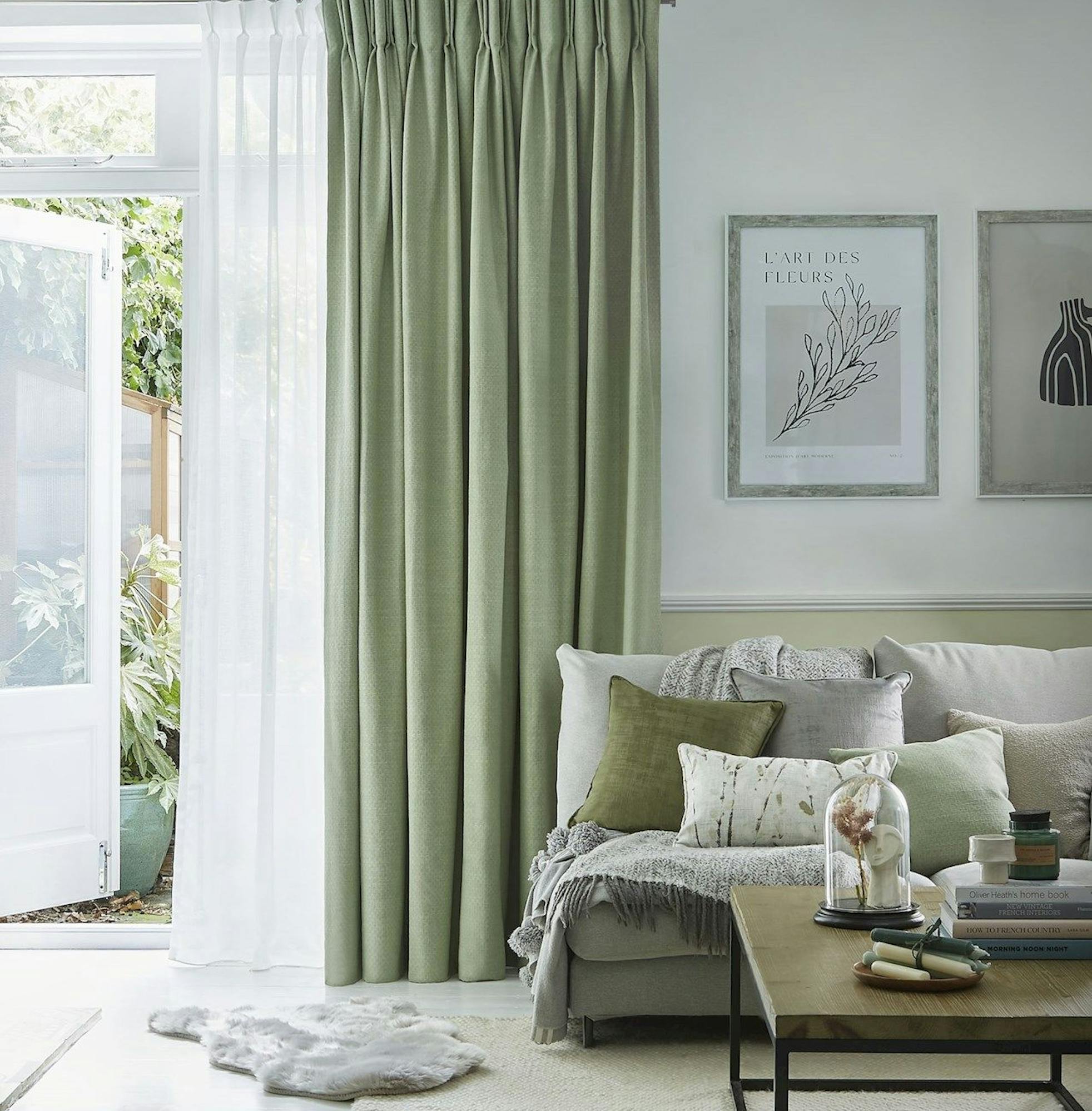 Pearl olive green floor length pinch pleat curtains paired with voiles in cosy living room