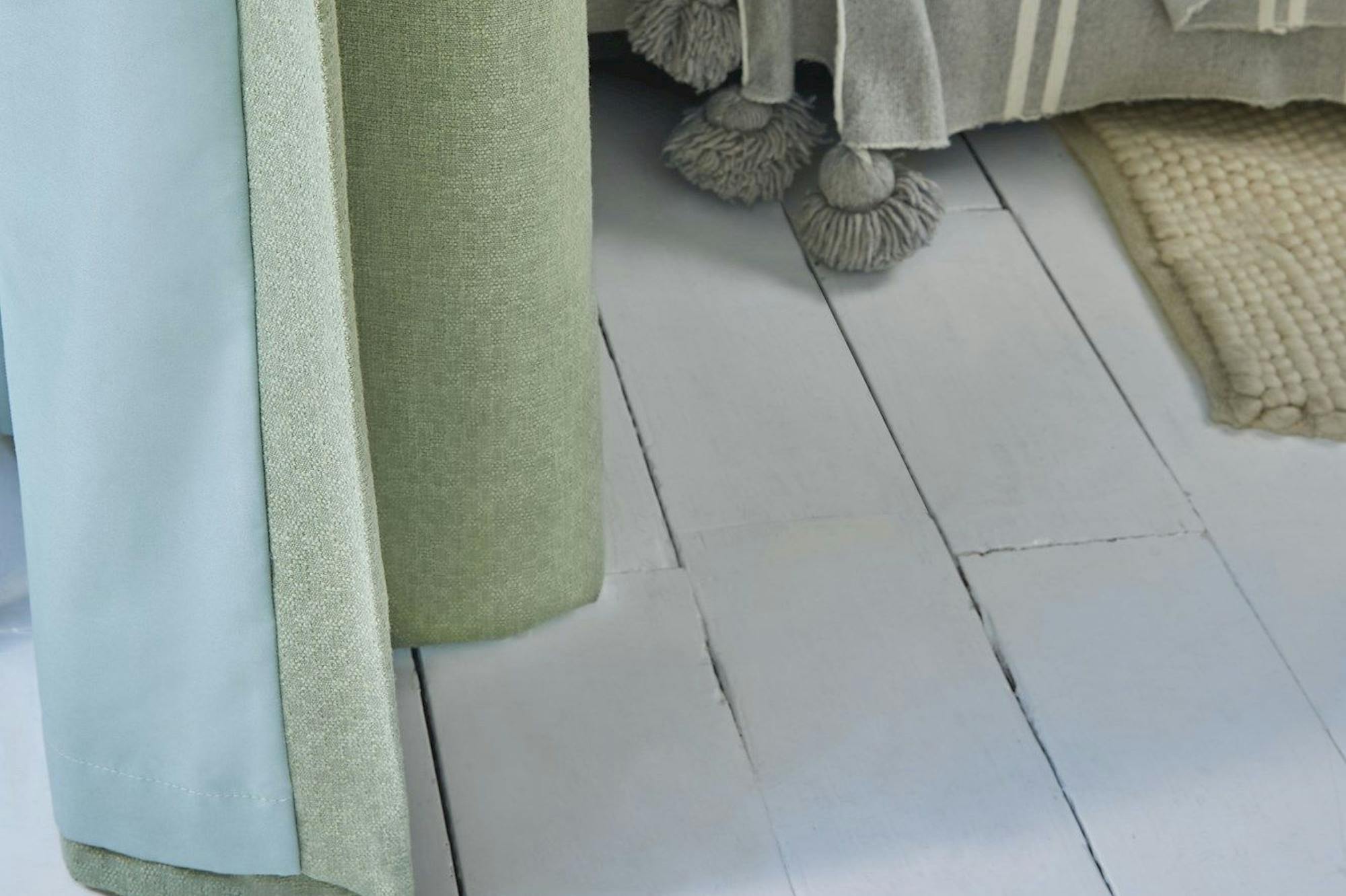 Pearl olive green floor length pinch pleat curtains paired with voiles in cosy living room