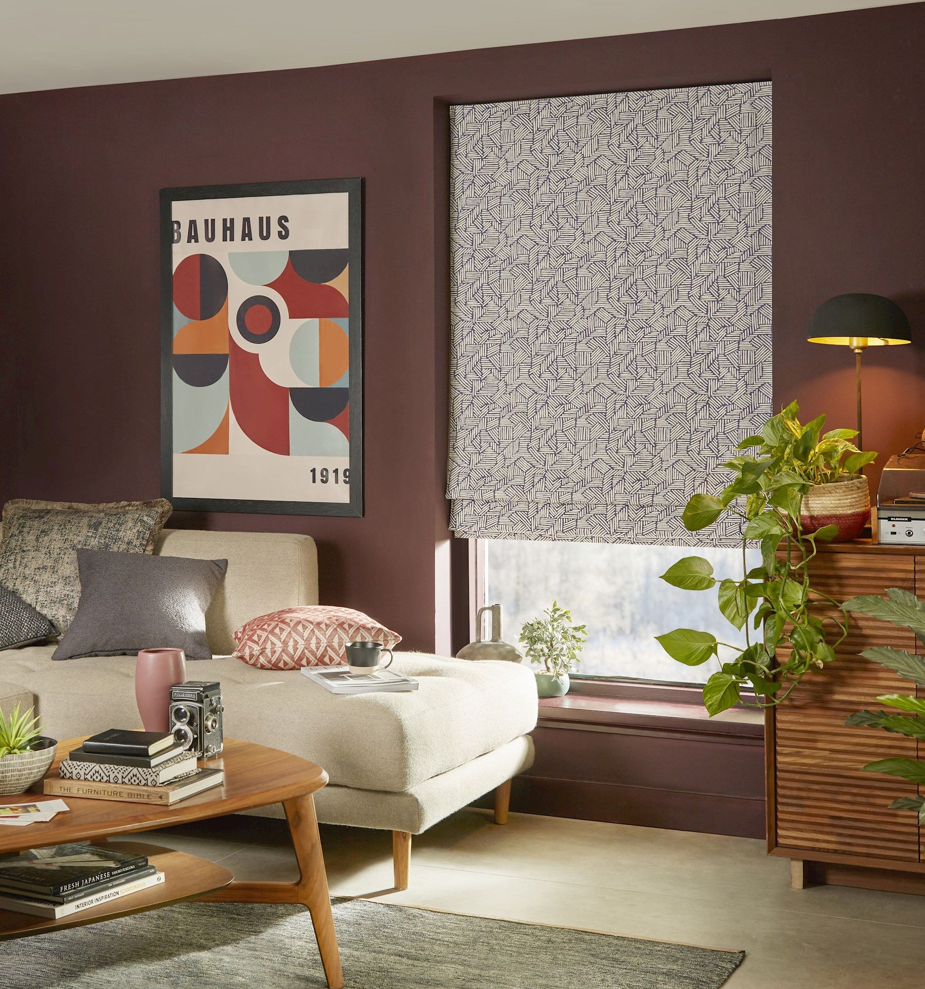Parquet blue roman blinds in cosy living room with deep red coloured walls