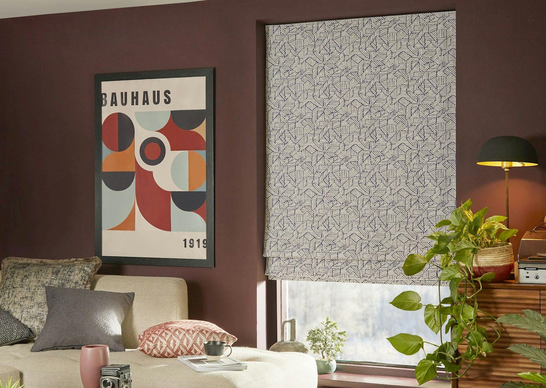 Parquet blue roman blinds in cosy living room with deep red coloured walls