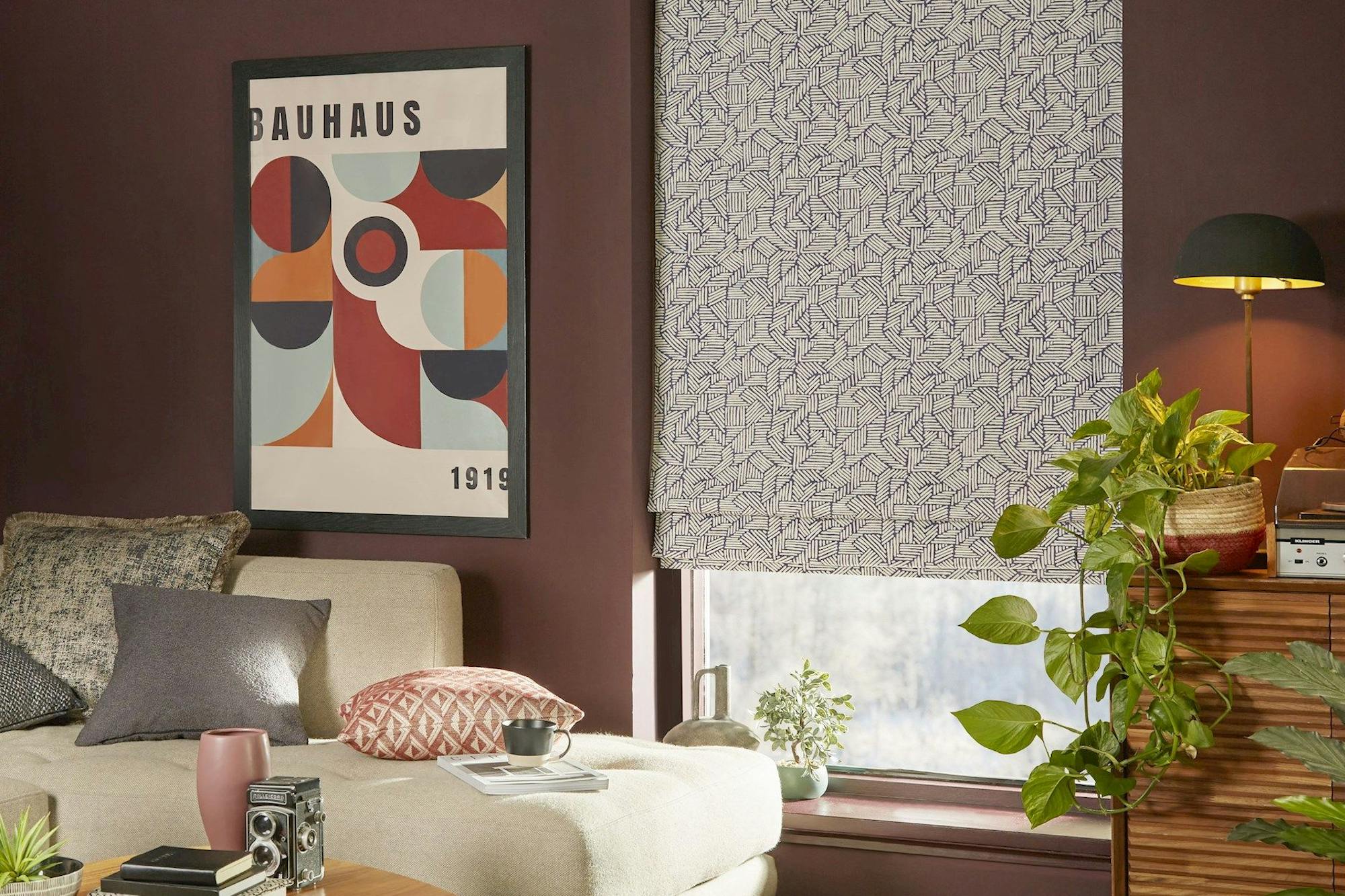 Parquet blue roman blinds in cosy living room with deep red coloured walls
