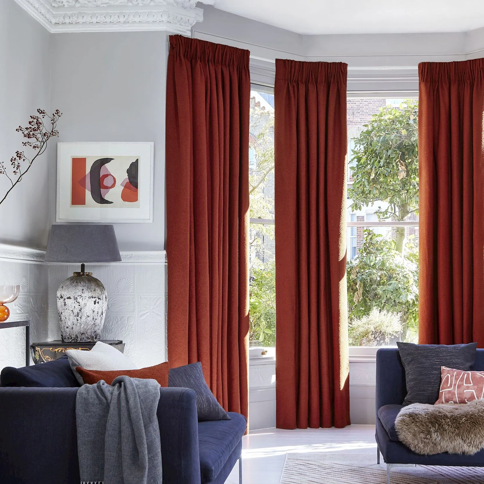 Two pairs of soho boucle spice pinch pleat curtains in bay window in living room