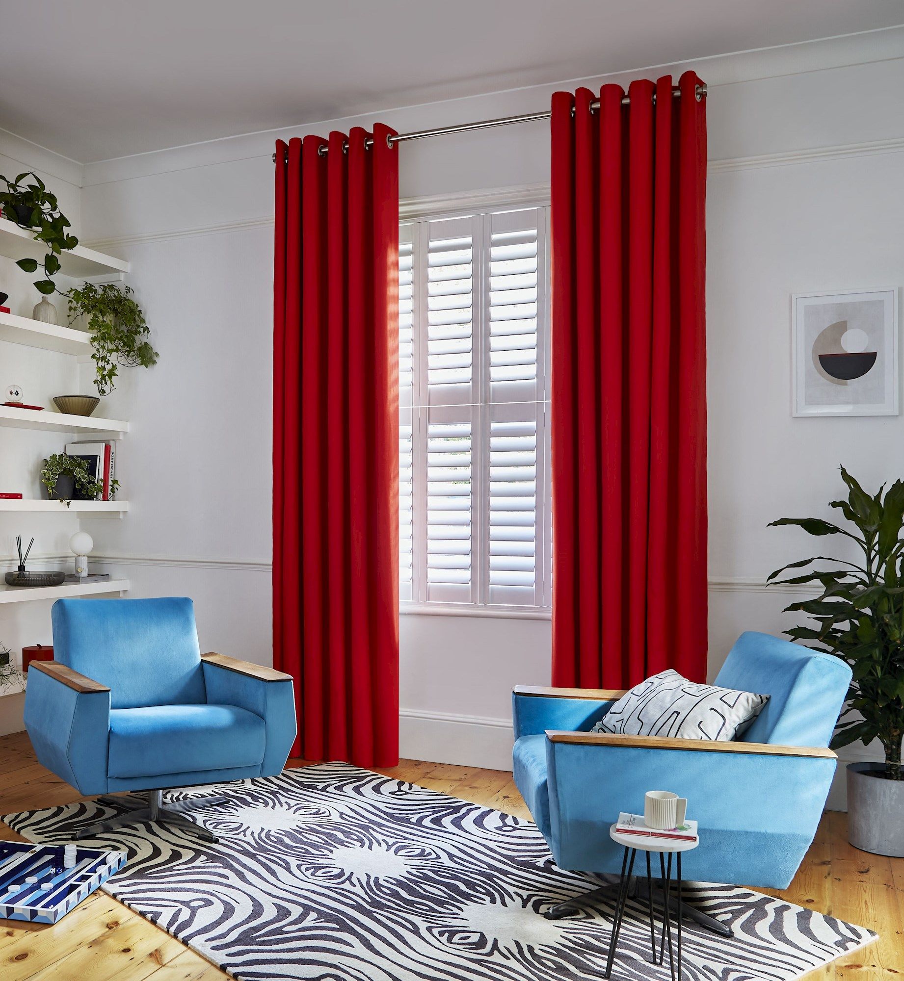 Faso fiesta floor length eyelet curtains paired with white shutters in modern living room