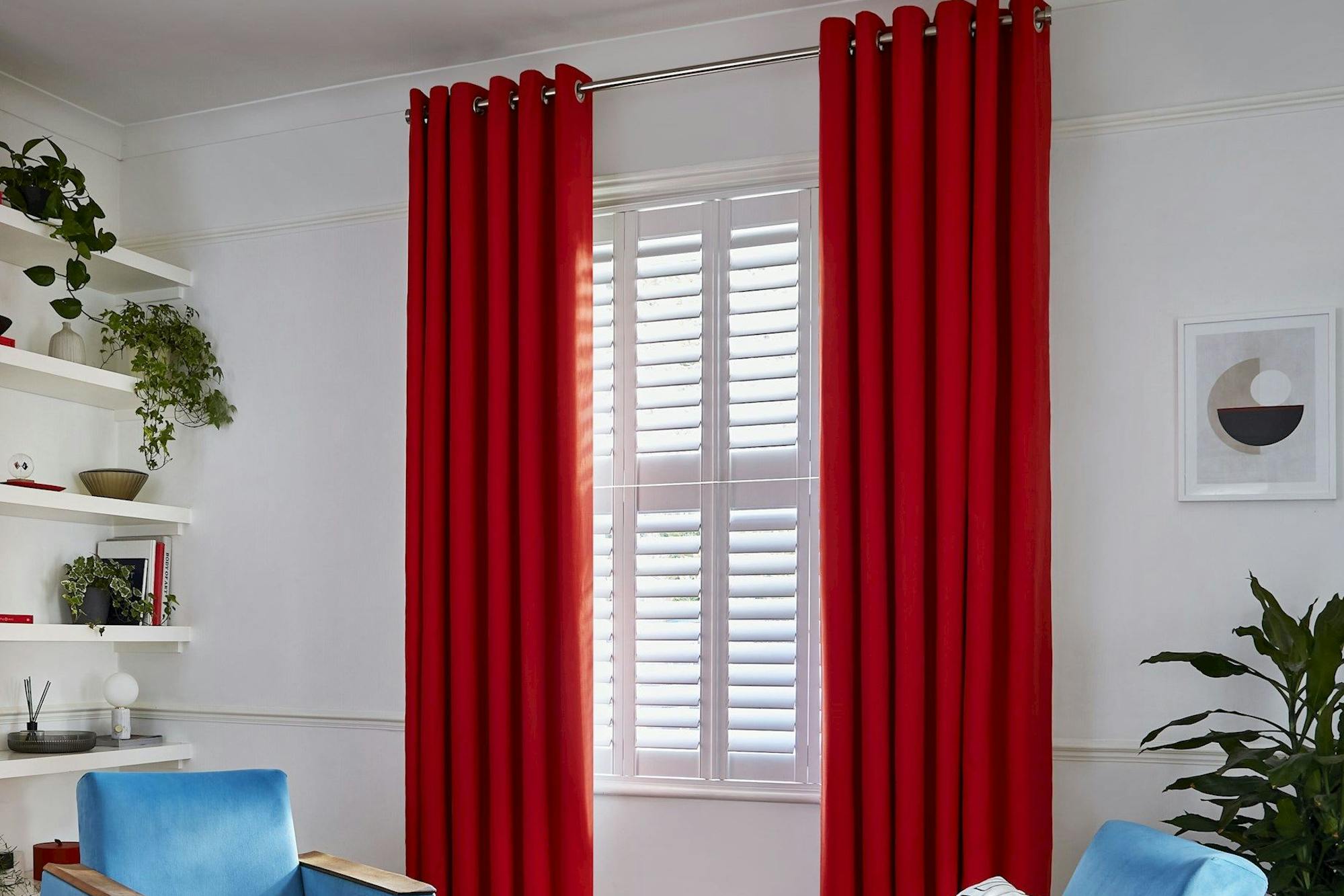 Faso fiesta floor length eyelet curtains paired with white shutters in modern living room