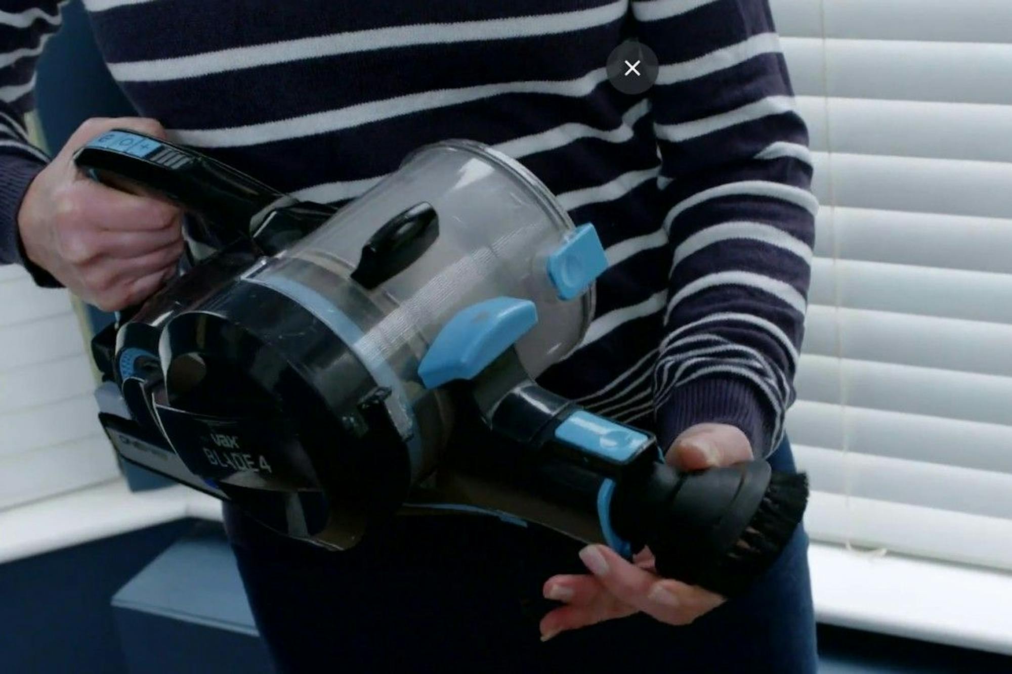 woman holding vacuum cleaner