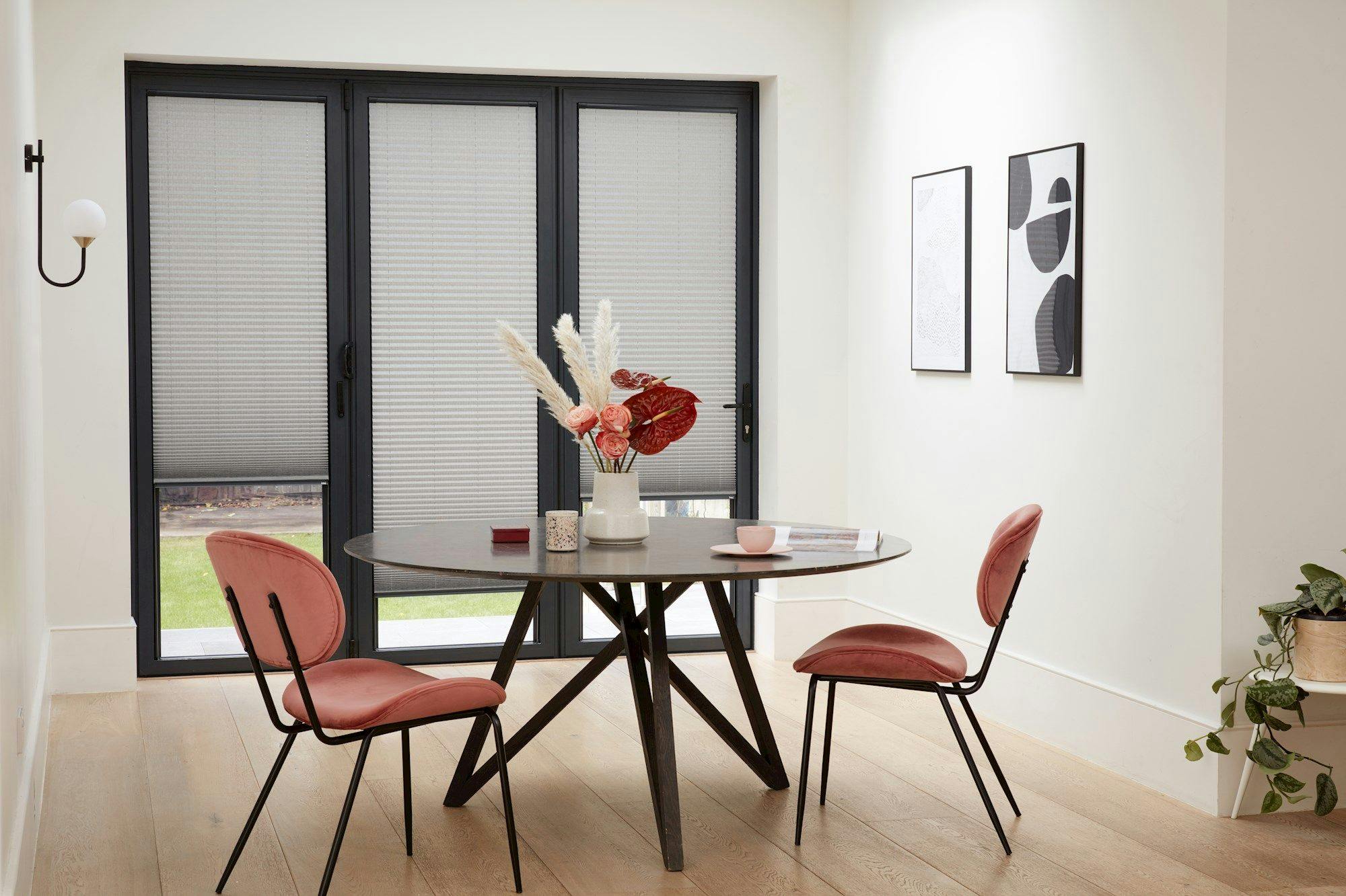INTU micro infusion concrete pleated blinds fitted on bifold doors in dining area with grey round table