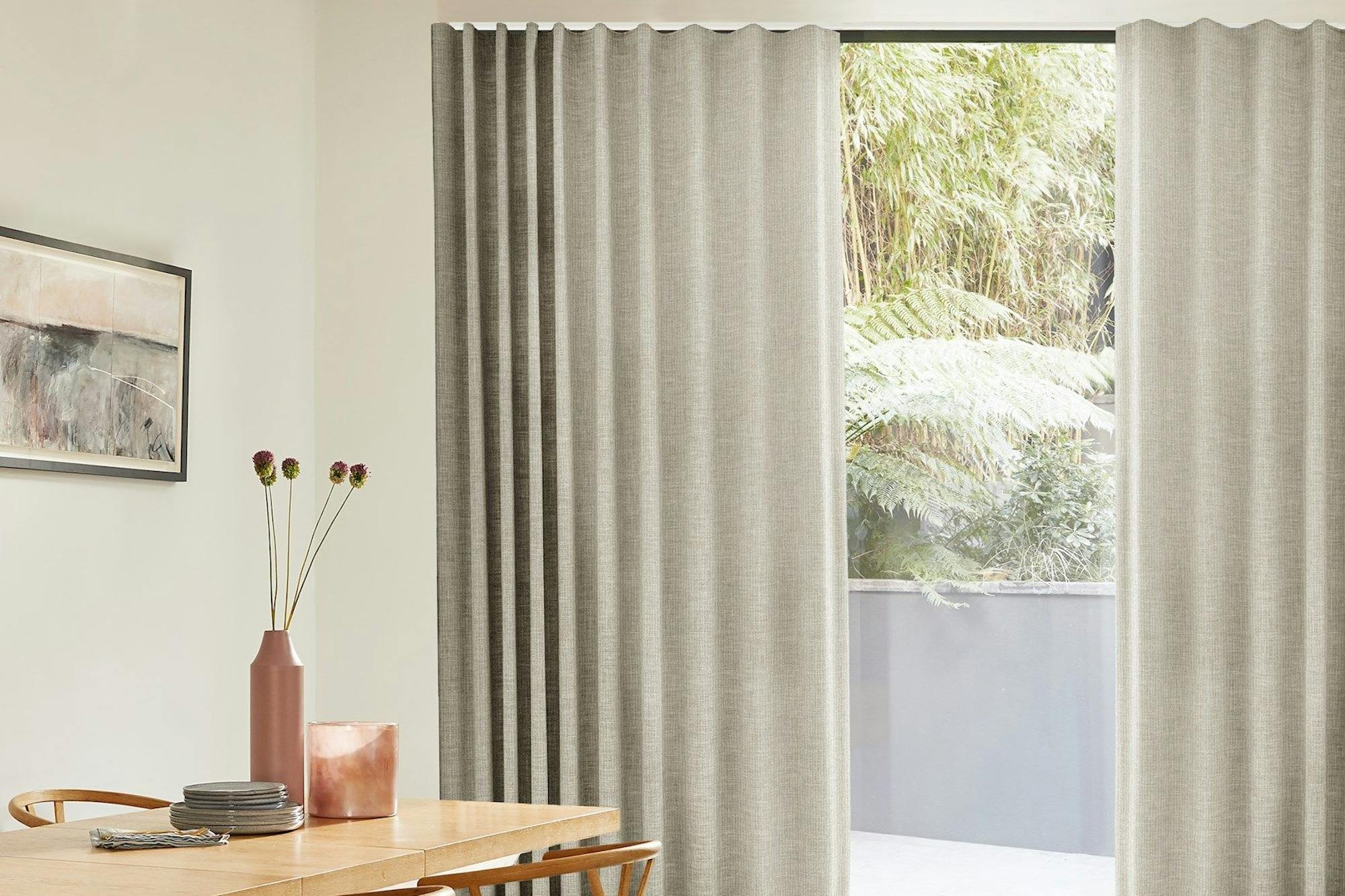 full height maisie almond wave curtains in a white dining room with wooden table
