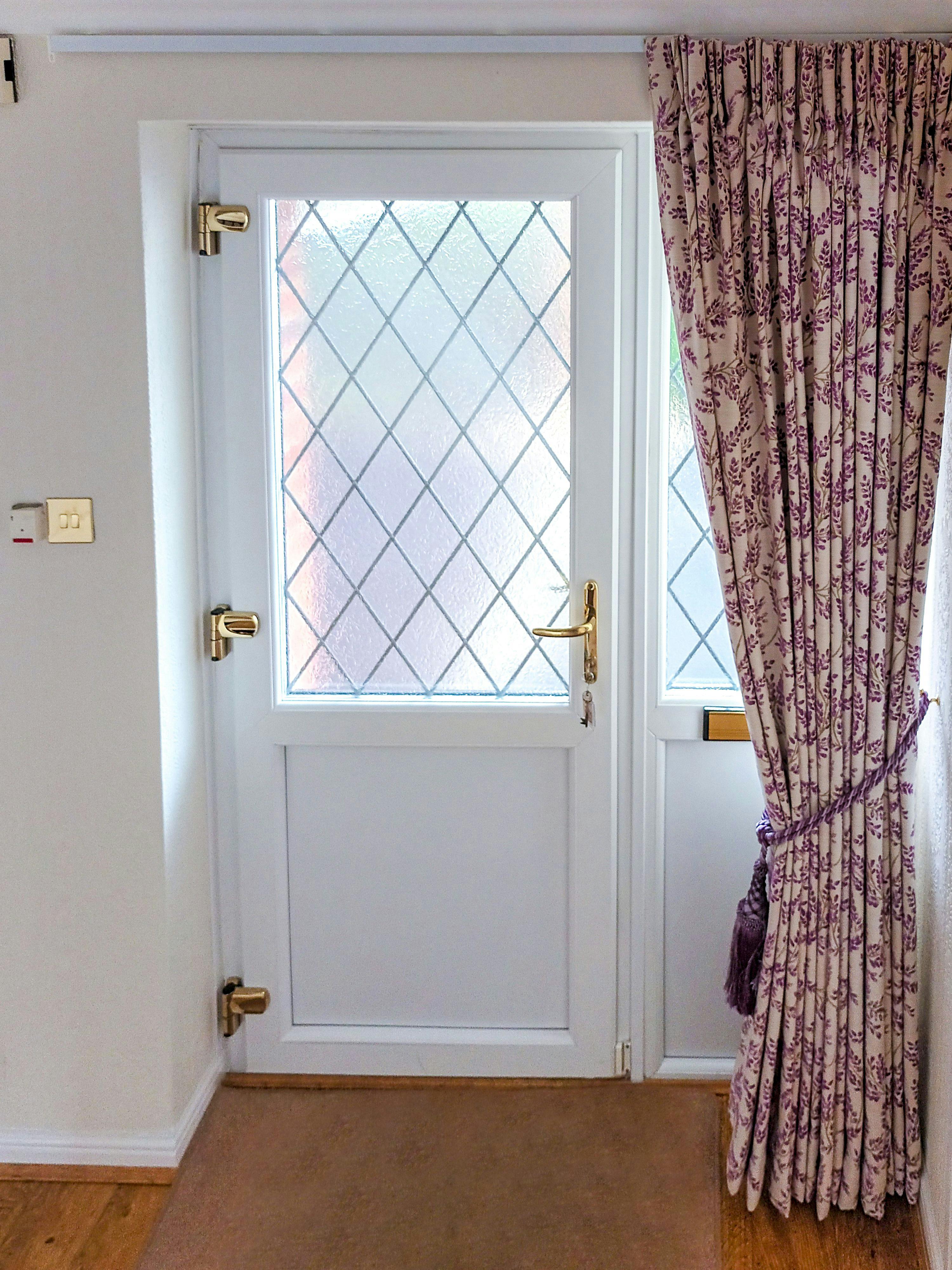 floor length delizia violet floral patterned curtains tied back over front door