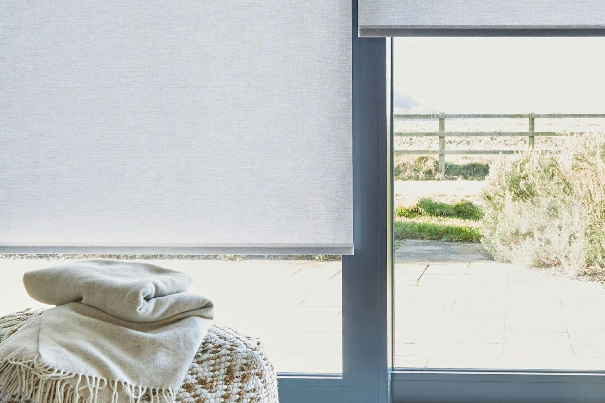 close up of light grey sustainable roller blinds on sliding patio doors