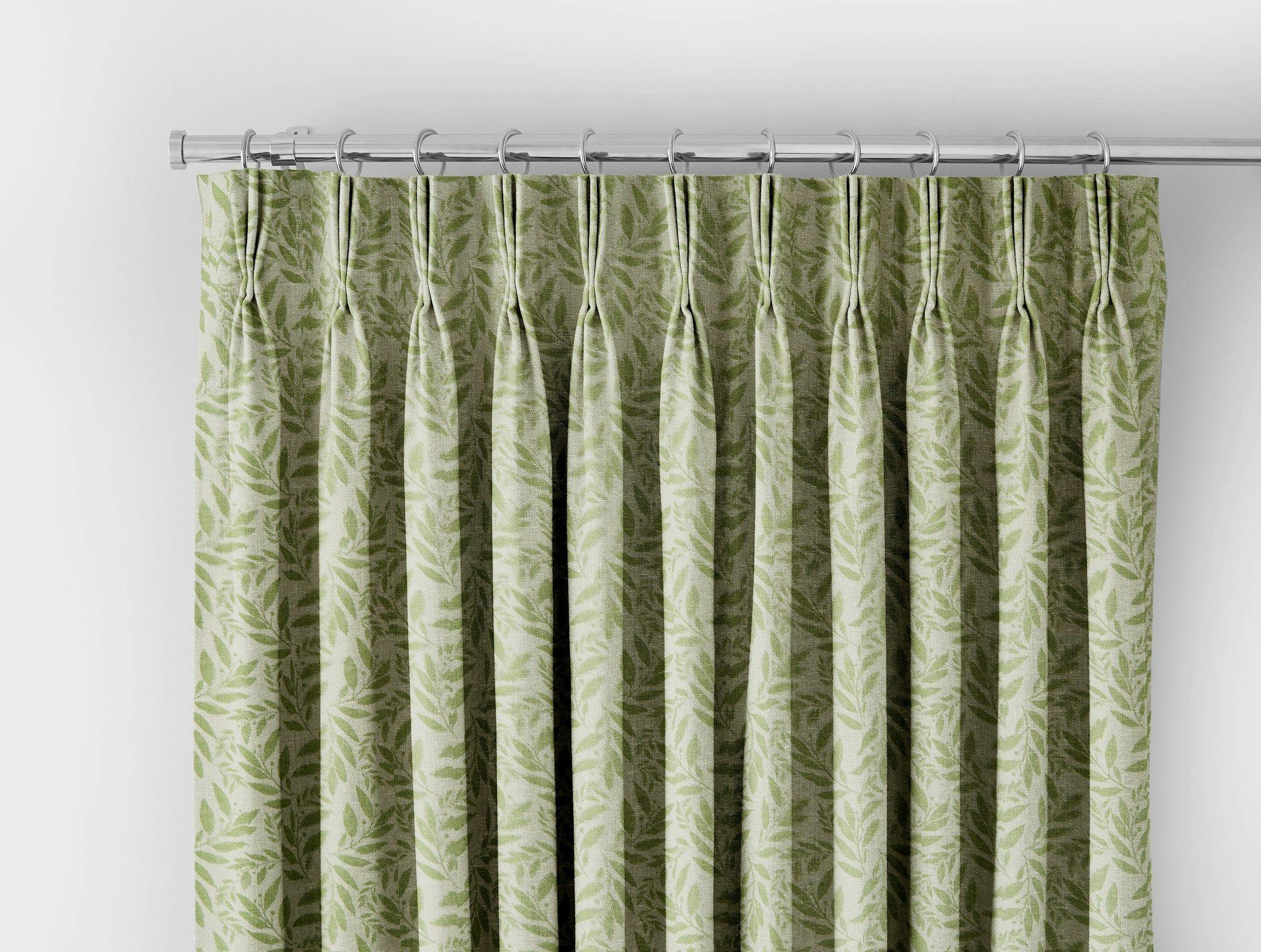 close up of green patterned curtain with leaves on