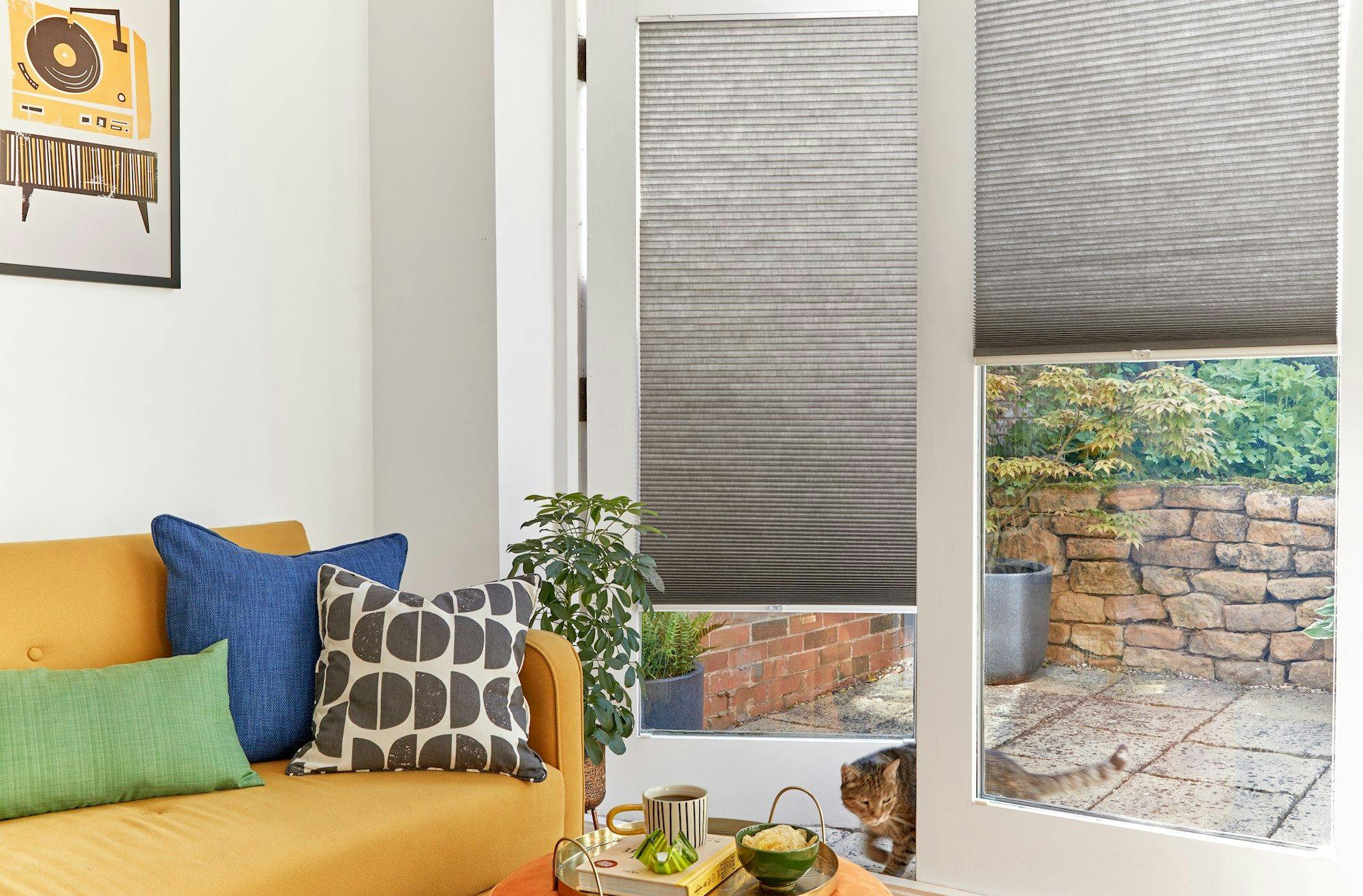 grey duette pleated blinds on large windows in open dining space