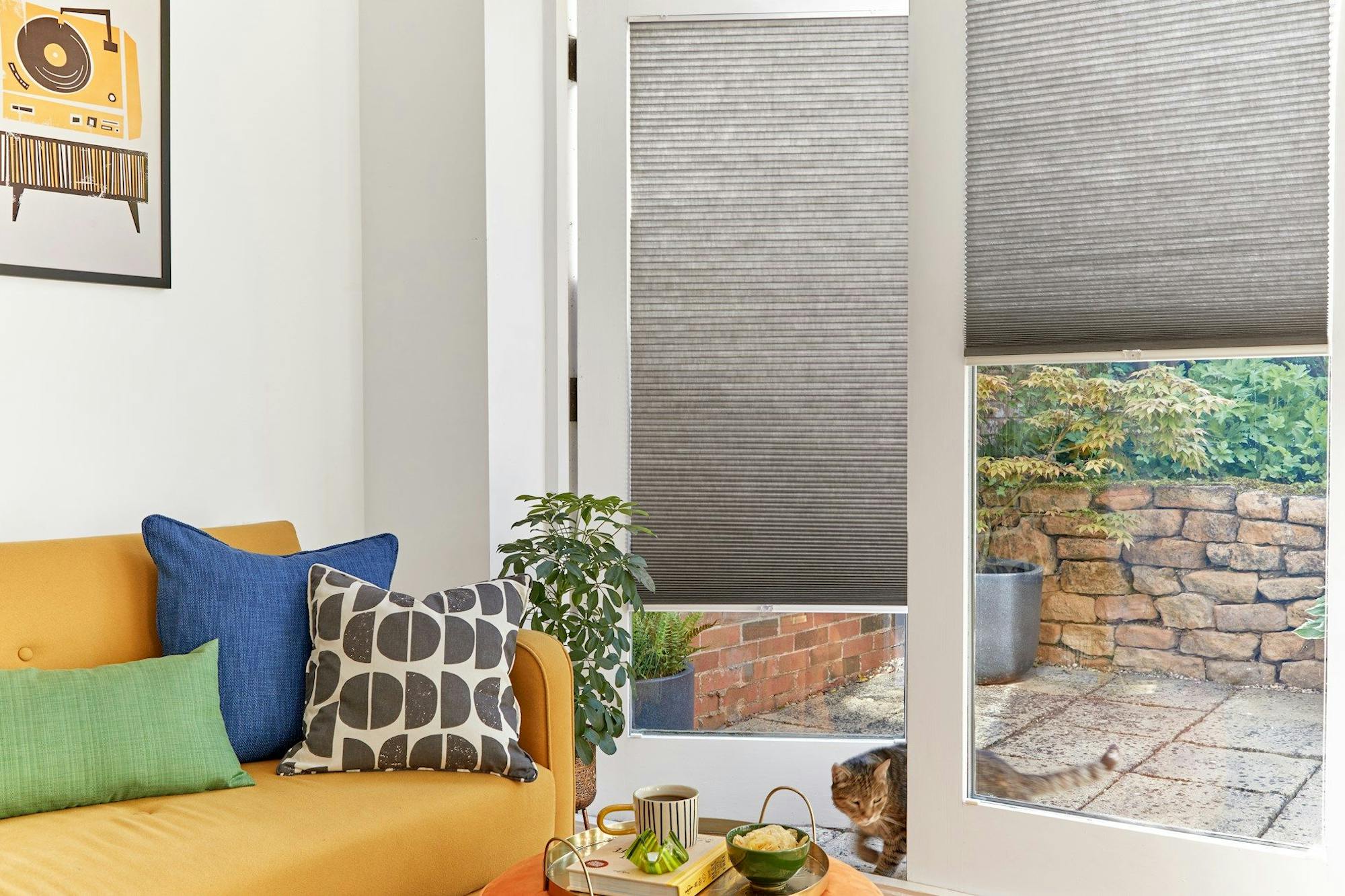 grey duette pleated blinds on large windows in open dining space