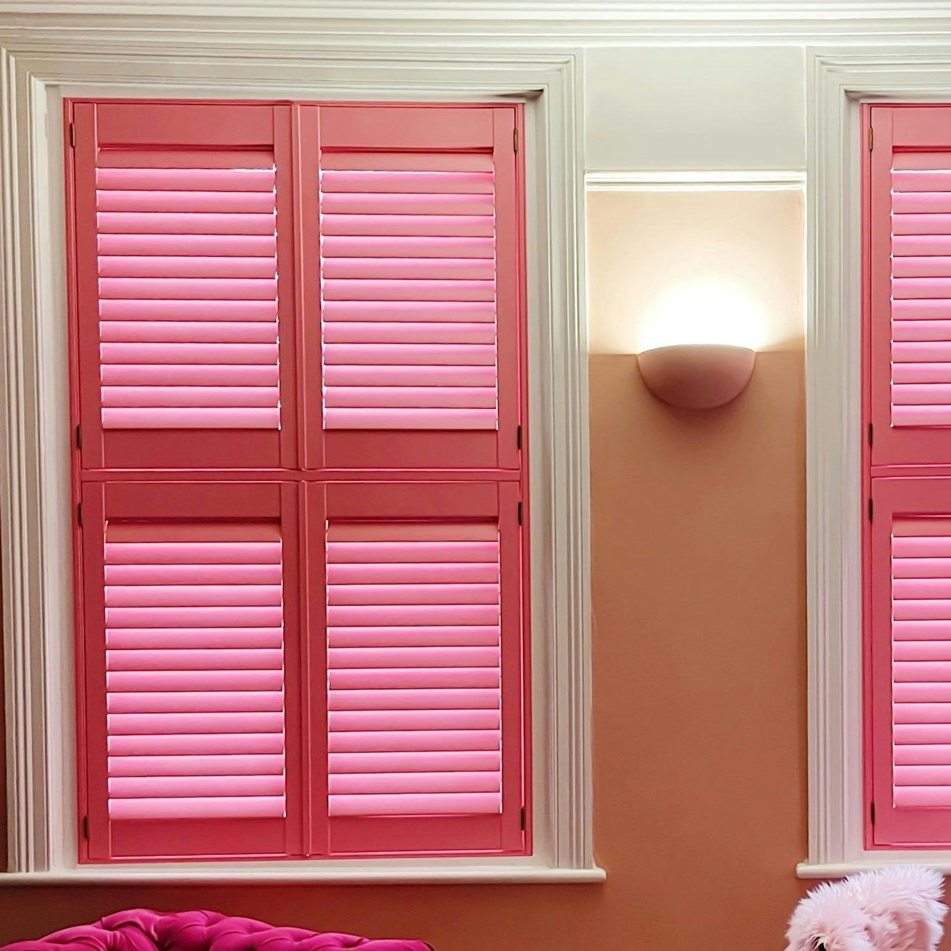 bright pink tier on tier shutters on windows in living room