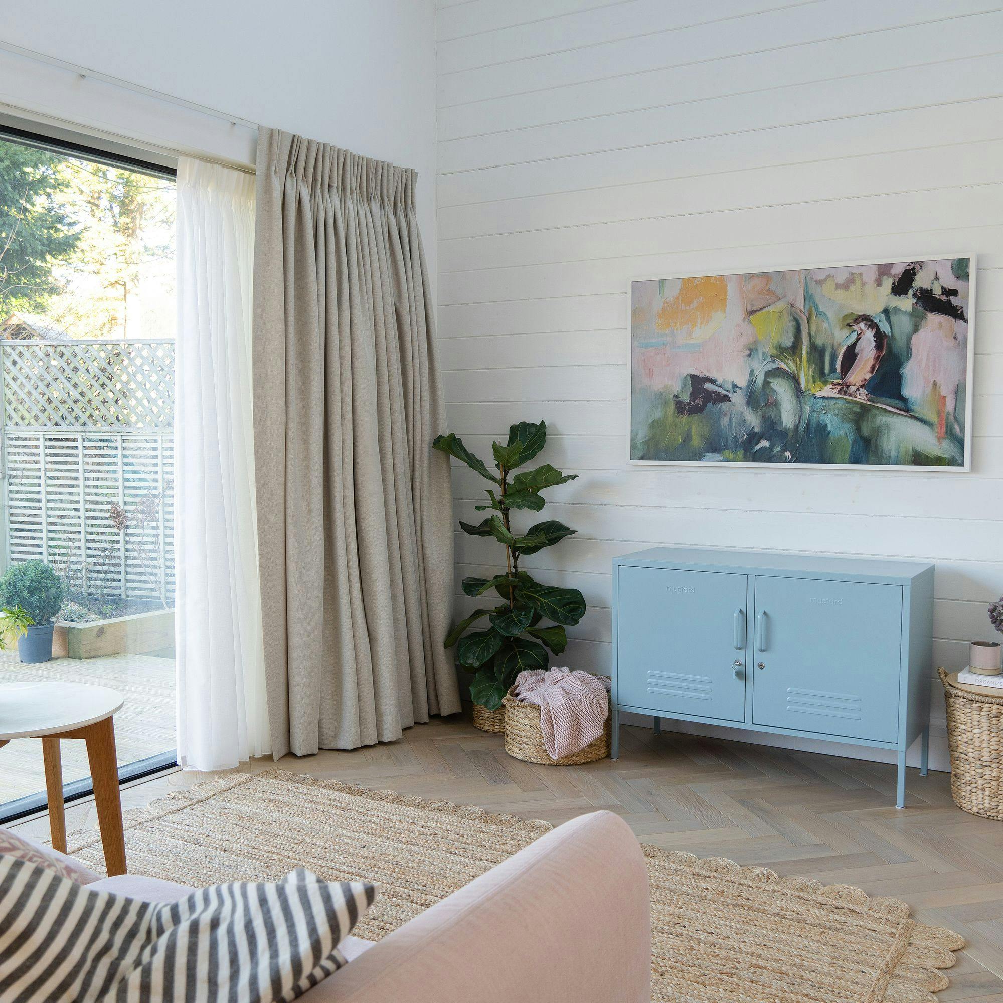 kendra-linen-pencil-pleat-curtains-over-bi-fold-doors-in-a-living-room