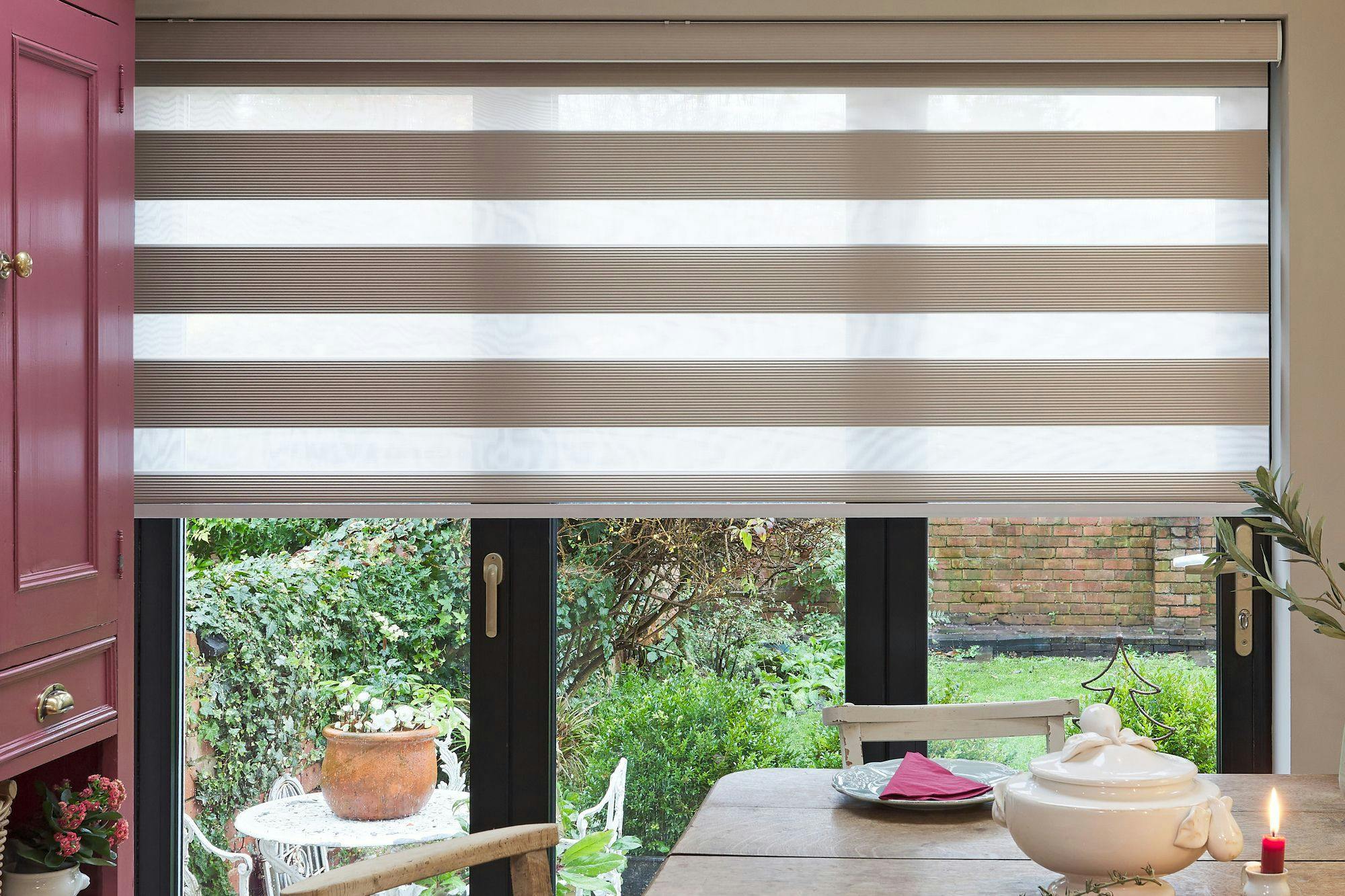 Beige day and night blind covering large garden bifold doors