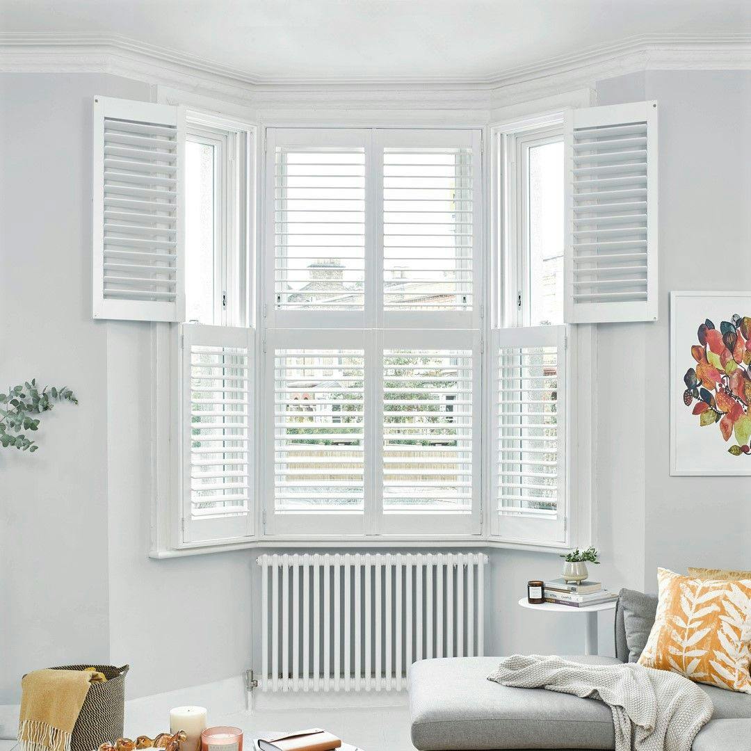 tier on tier white shutters in a cosy living room