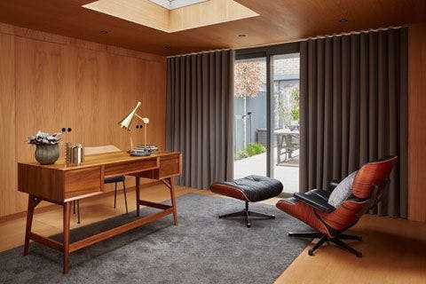Inside George Clarke's home office with Wave Curtains in Tetbury Charcoal fabric and Cushions in Morton Tar, Tetbury Black and Huxley Dove Fabric.
