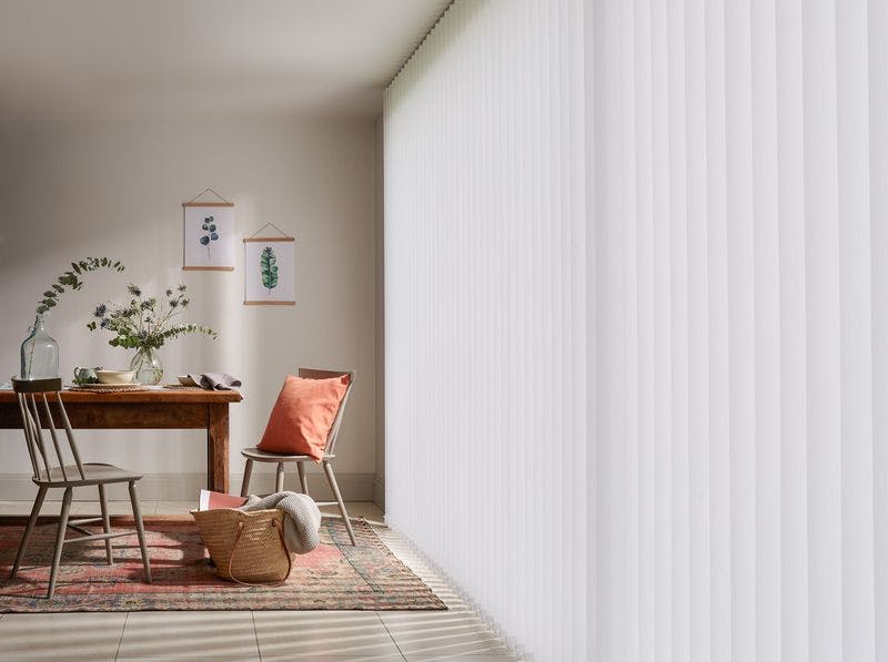 Modern rustic dining room with full length white vertical blinds