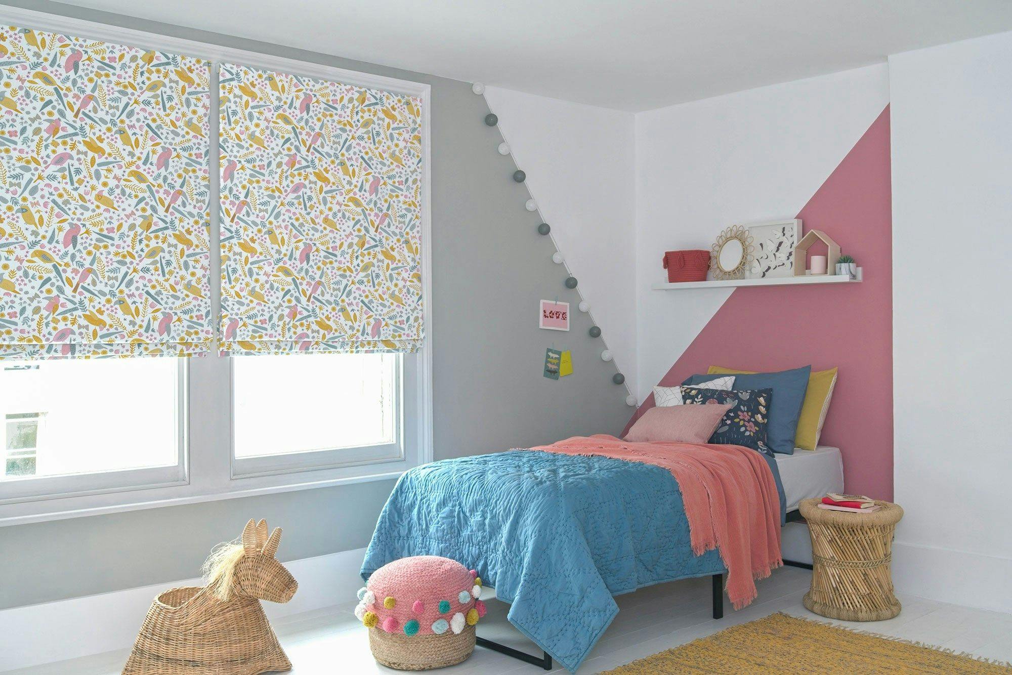 Kids bedroom windows dressed with roman blinds featuring toucan print on whitebackground