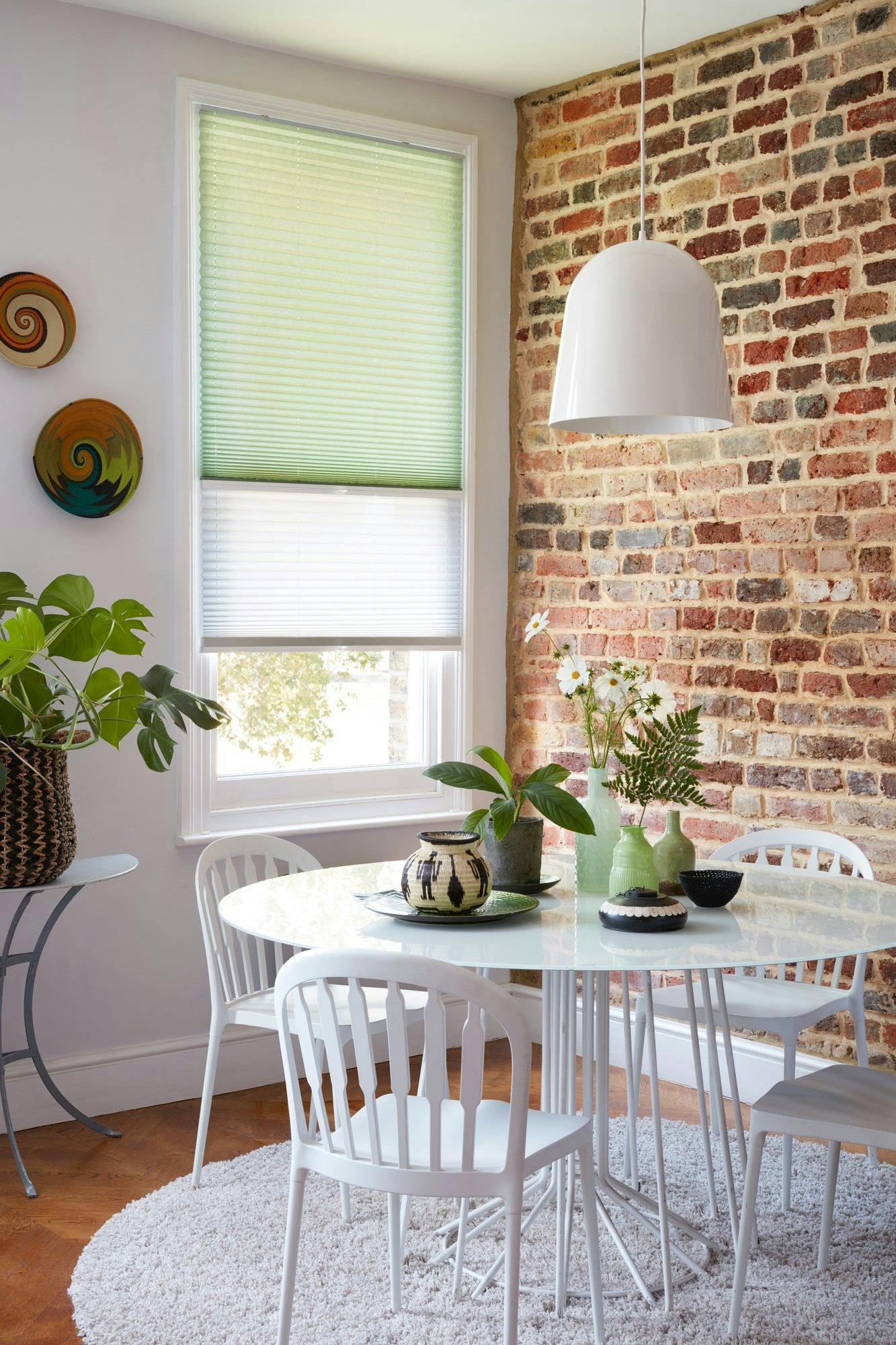 Mint green and sheer white Transition Pleated blinds dressed on the window in dining room.