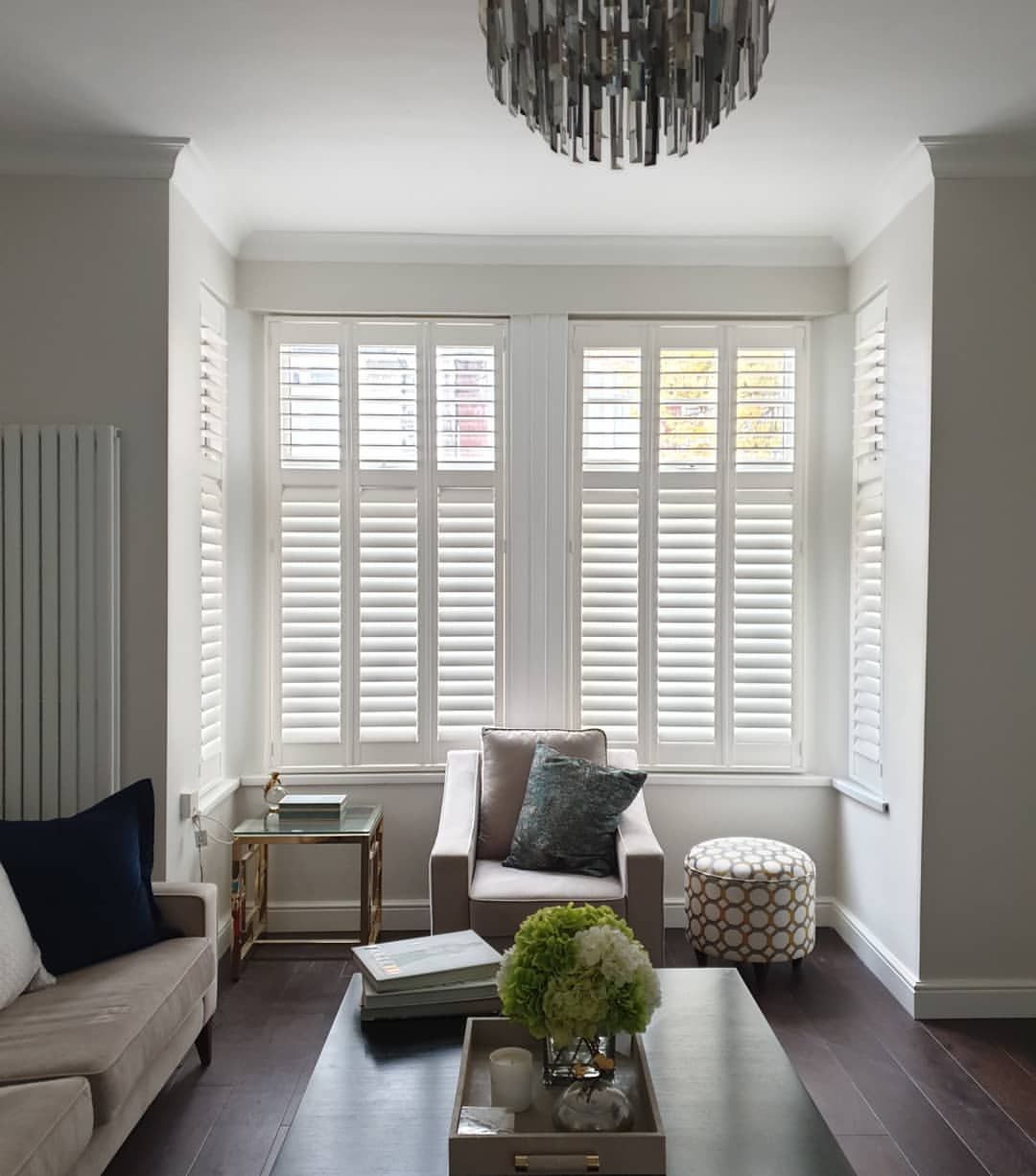White shutters installed on bay windows of living room