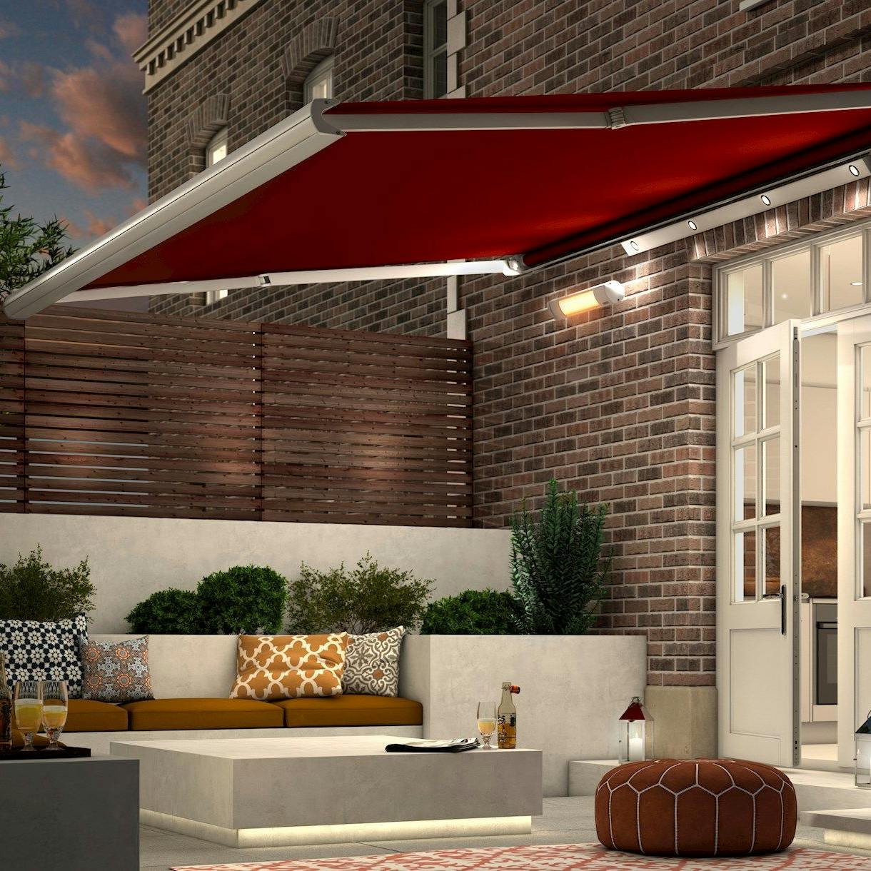 Garden Awning in Verona Rouge fabric extended over garden patio in the evening