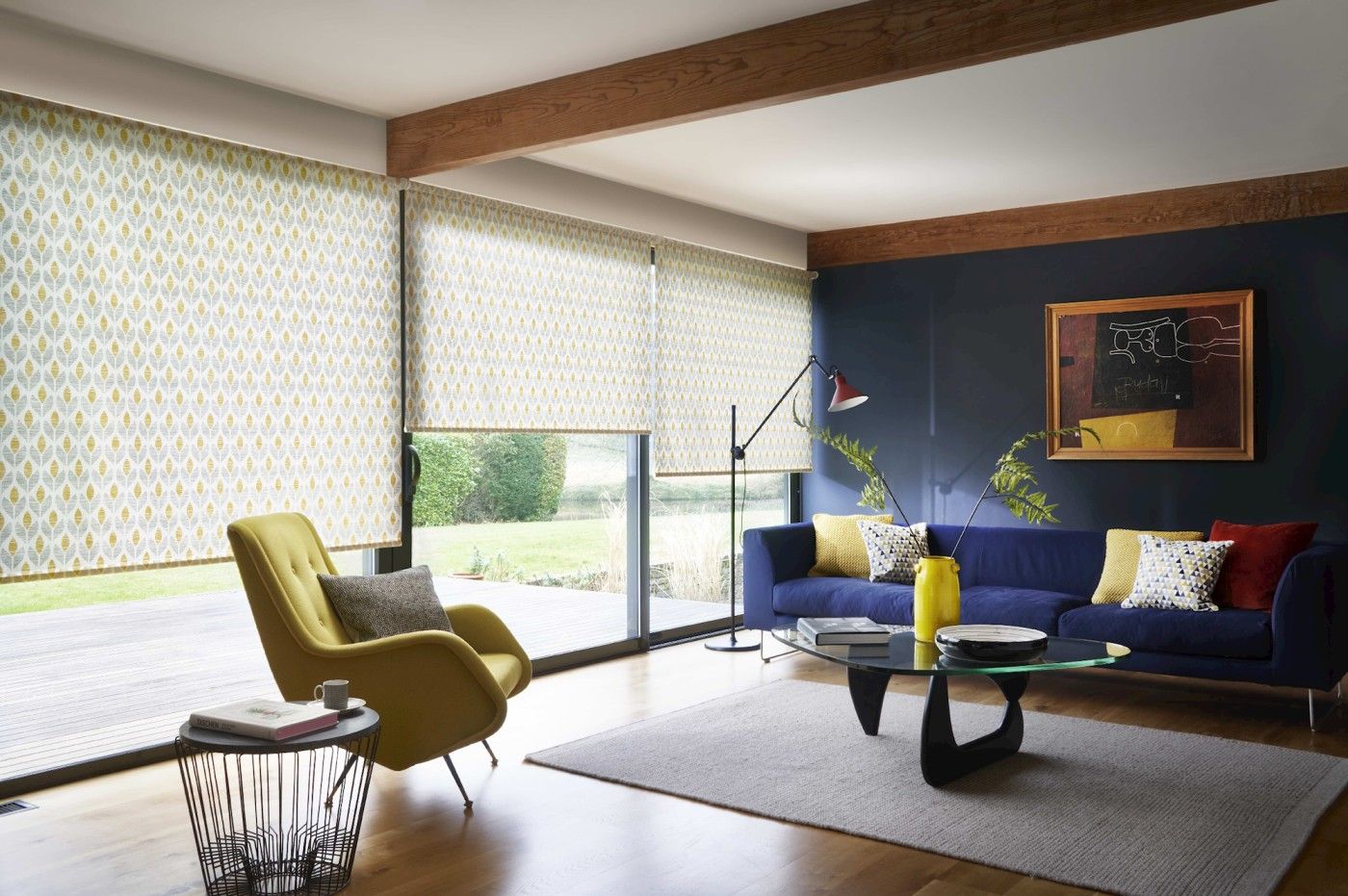 Modern living room with retro style decor and wide windows dressed with retro yellow floral roller blinds