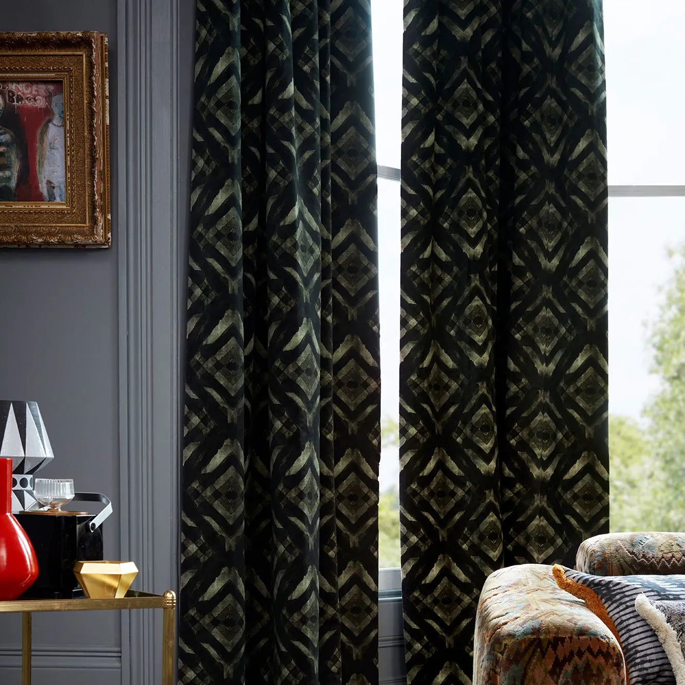 Dark and Eccentric Living Room Decorated with Green and Black velvet curtains from the Abigail Ahern collection