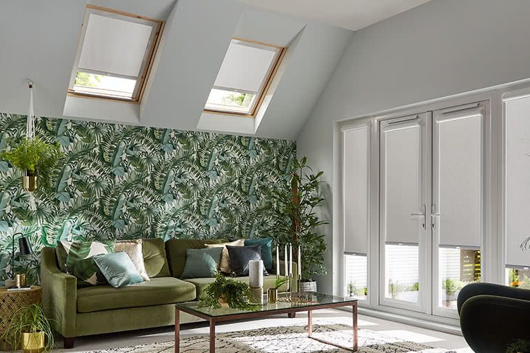 Living room with sofa, coffee table and Acacia Silver bloc blinds on a Velux window
