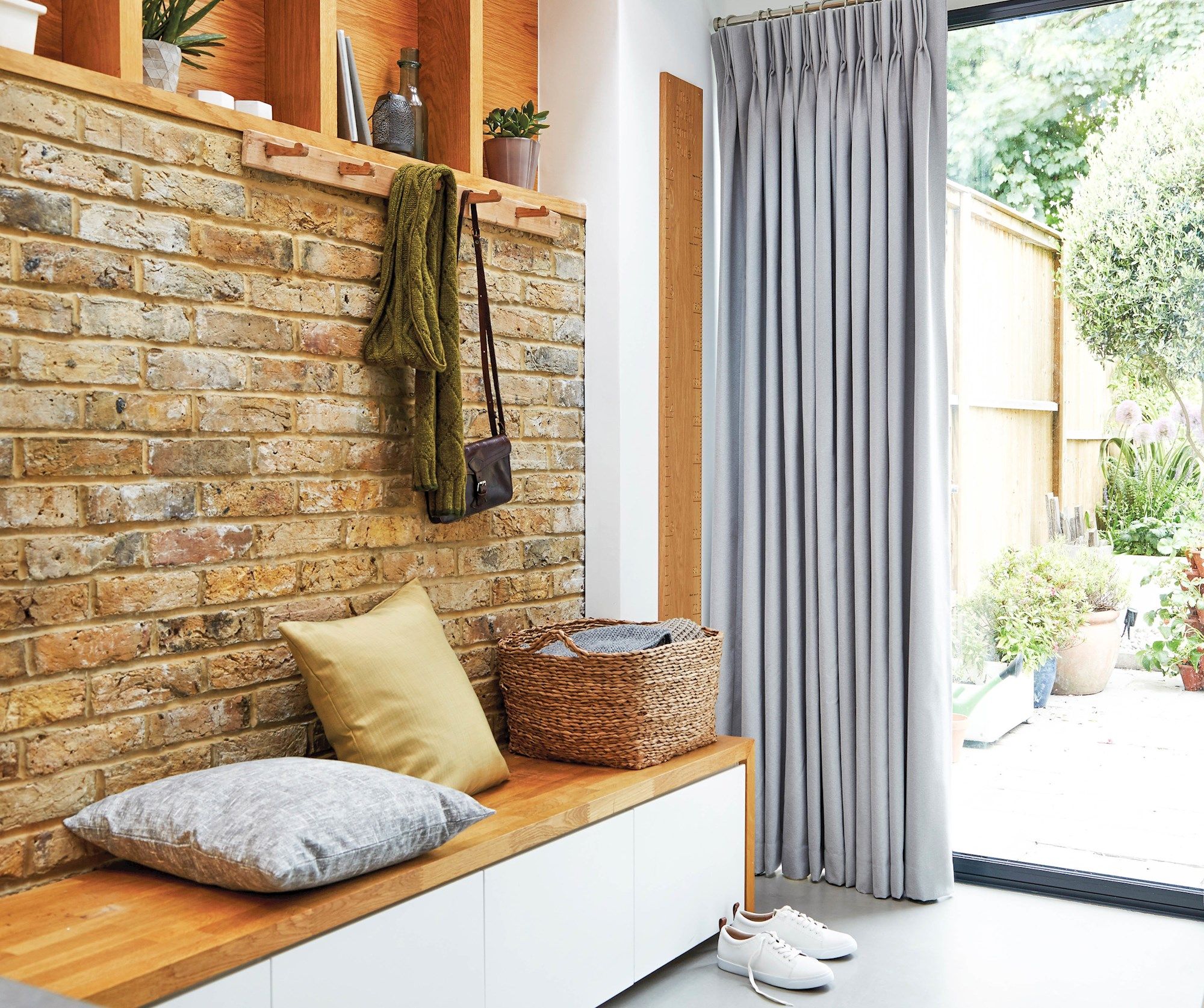 Boot room with exposed brickwork and dove grey curtains