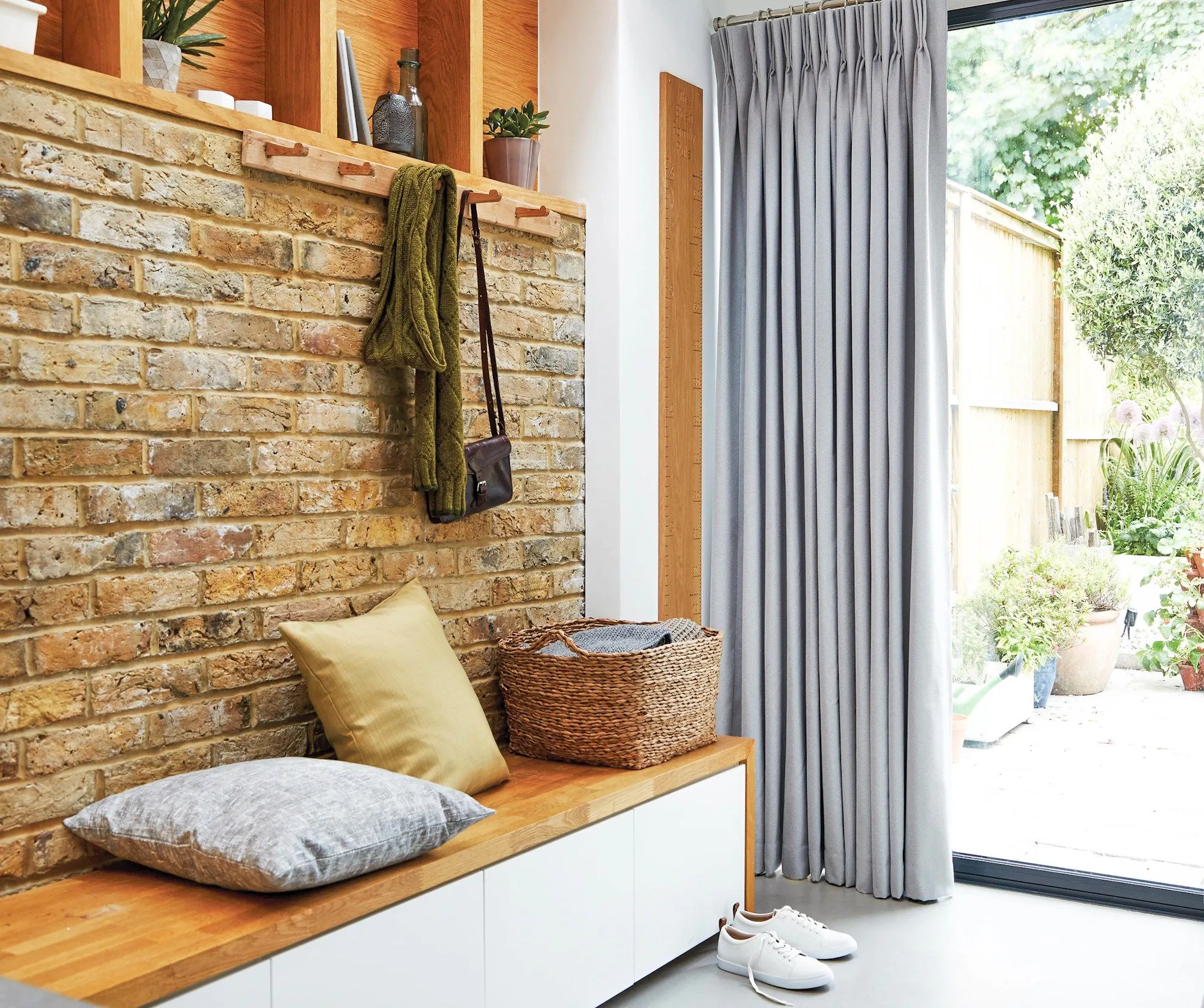 Boot room with exposed brickwork and dove grey curtains