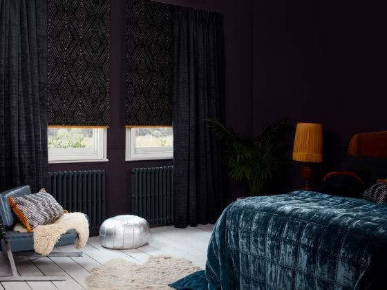 Cley Mole curtains and Beats Haze Roman with Colette Soleil fringing in dark bedroom