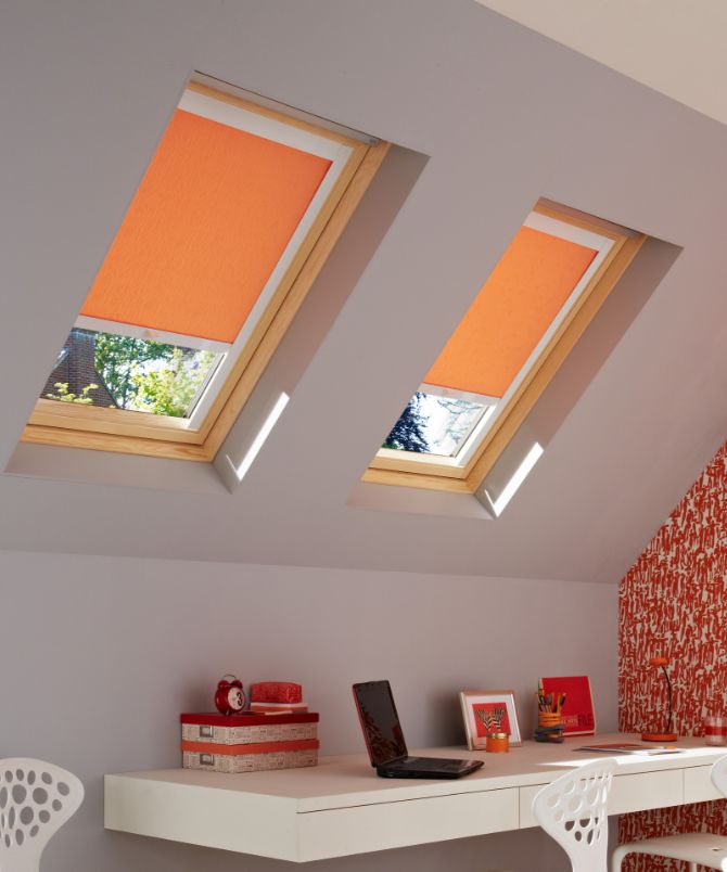 loft bedroom with sherborne orange roller skylight blinds