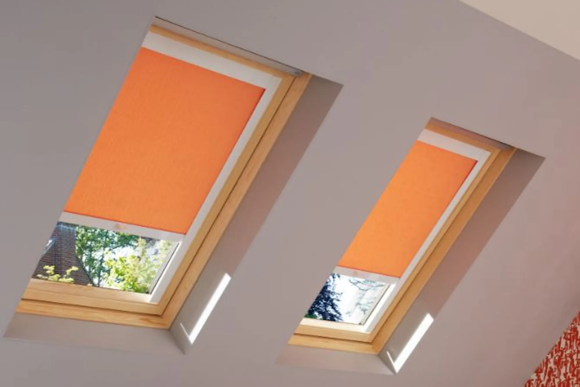 loft bedroom with sherborne orange roller skylight blinds
