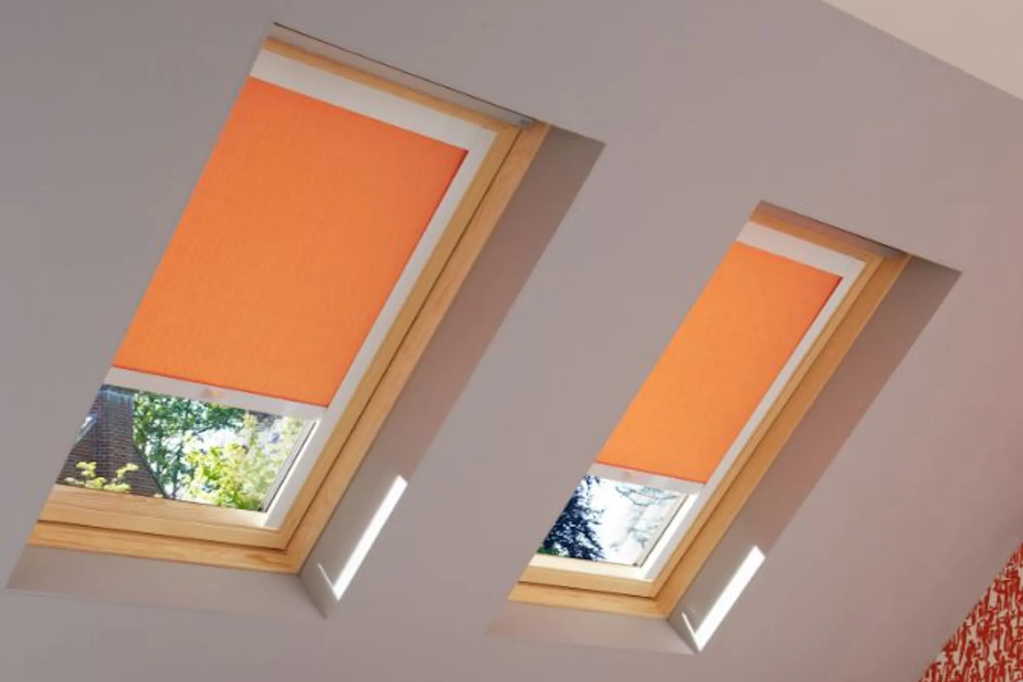 loft bedroom with sherborne orange roller skylight blinds
