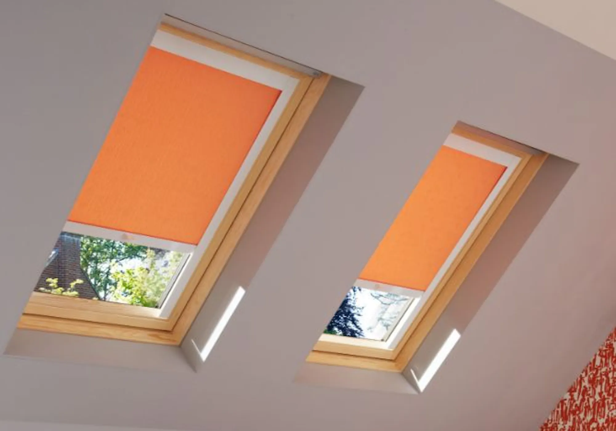 loft bedroom with sherborne orange roller skylight blinds