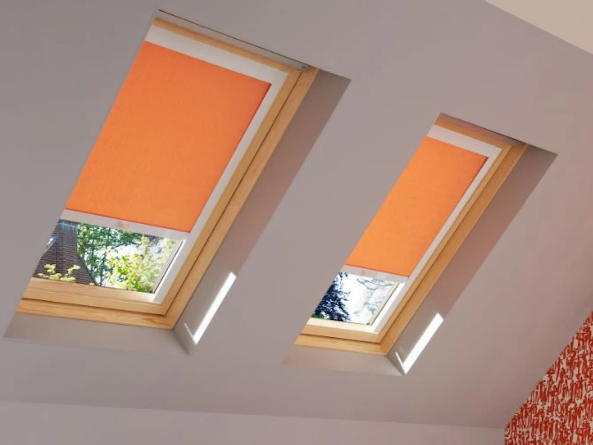 loft bedroom with sherborne orange roller skylight blinds
