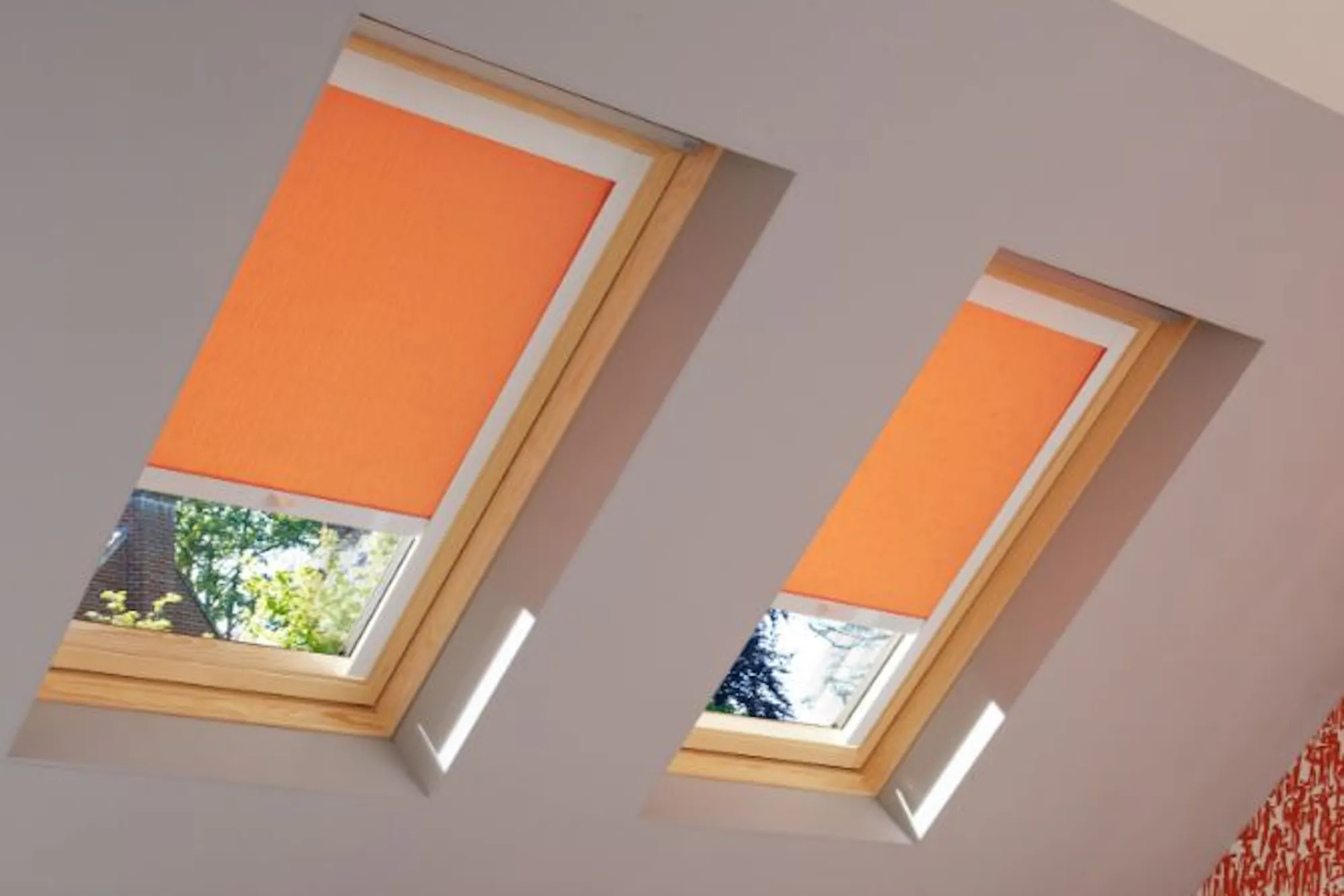 loft bedroom with sherborne orange roller skylight blinds