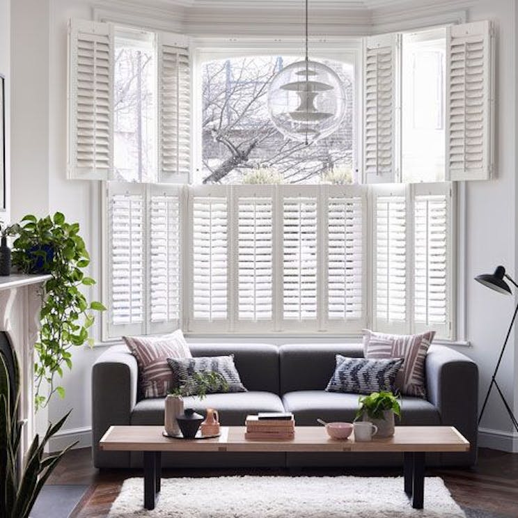 Windsor Silk White tier-on-tier shutters in a living room