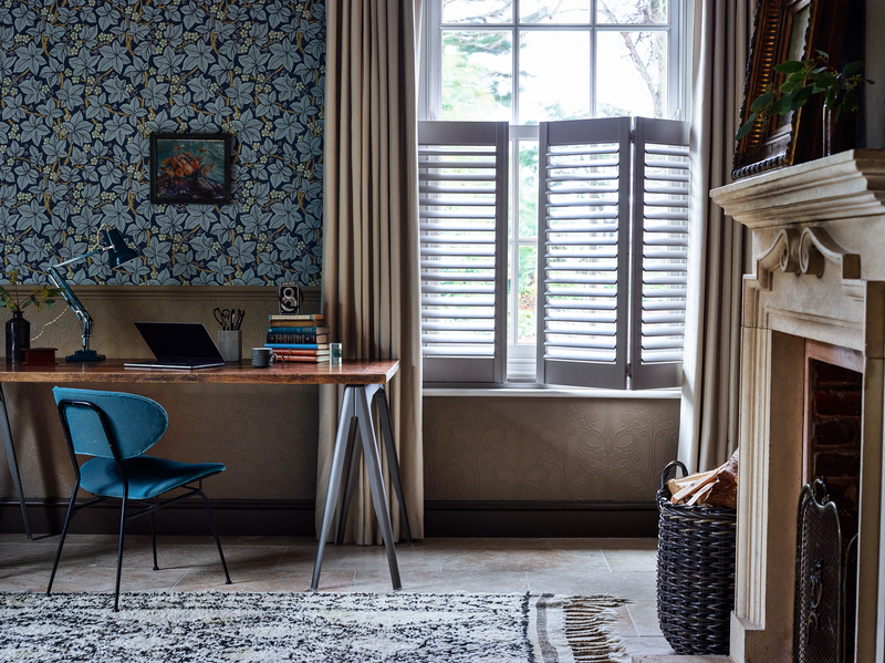 Home office with curtains layered over cafe style shutters