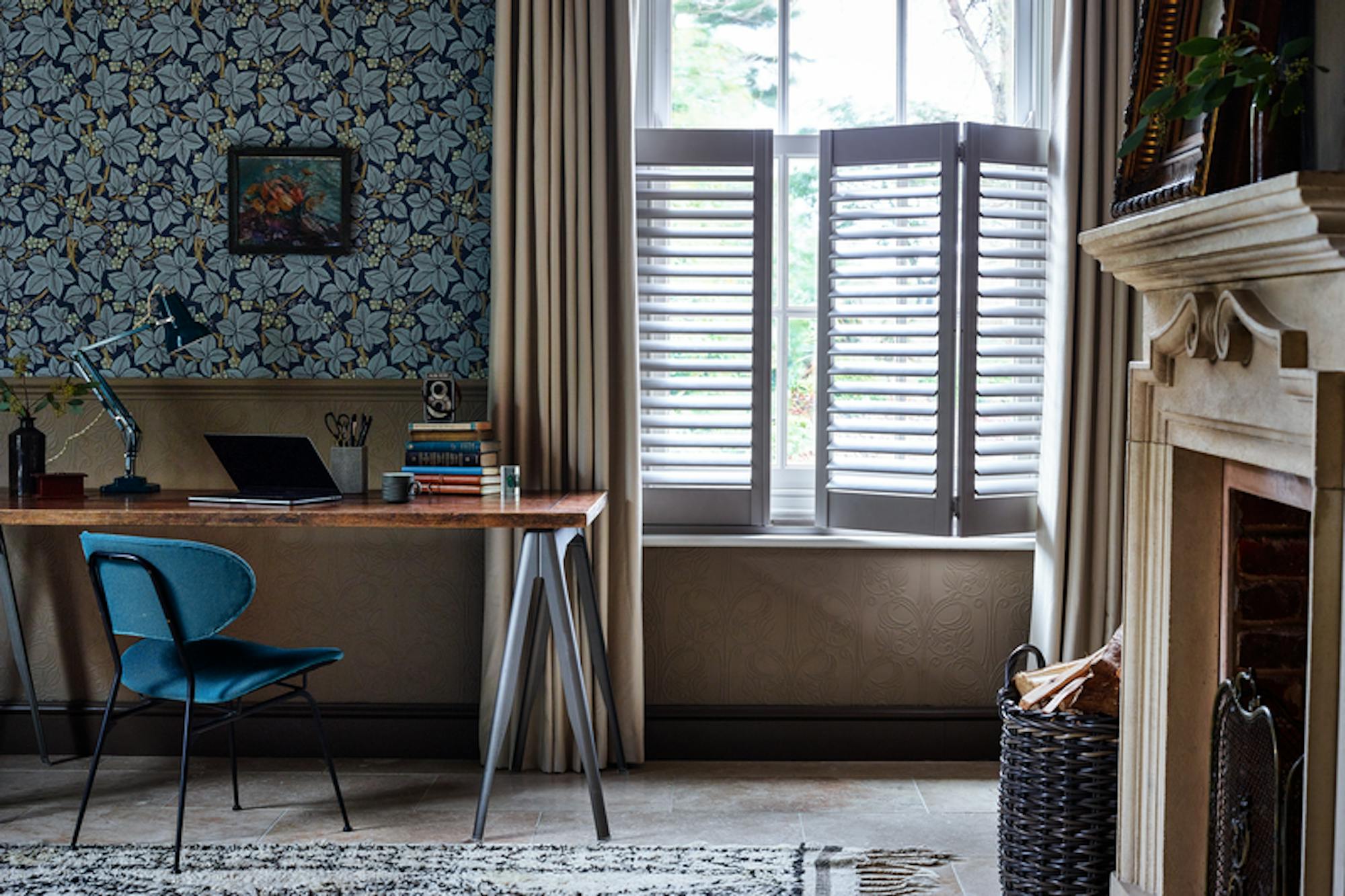 Home office with curtains layered over cafe style shutters